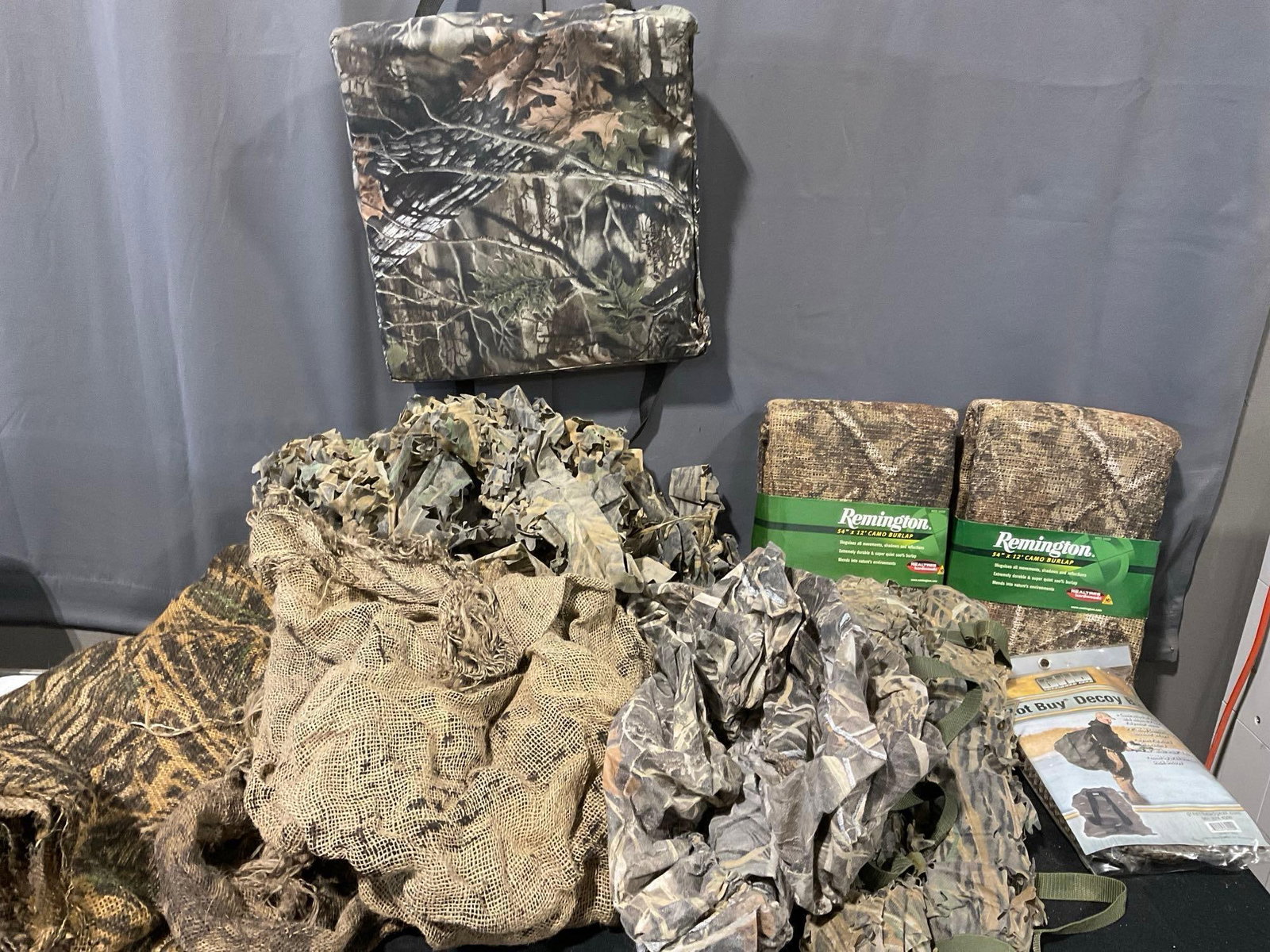 Good Sized Variety of Camo Burlap, 2x New Remington, Foam Seat Pad & more: Appears to be in good shape. The piece measures approx 18h x 33w x 21d inches. See pics. E-5600