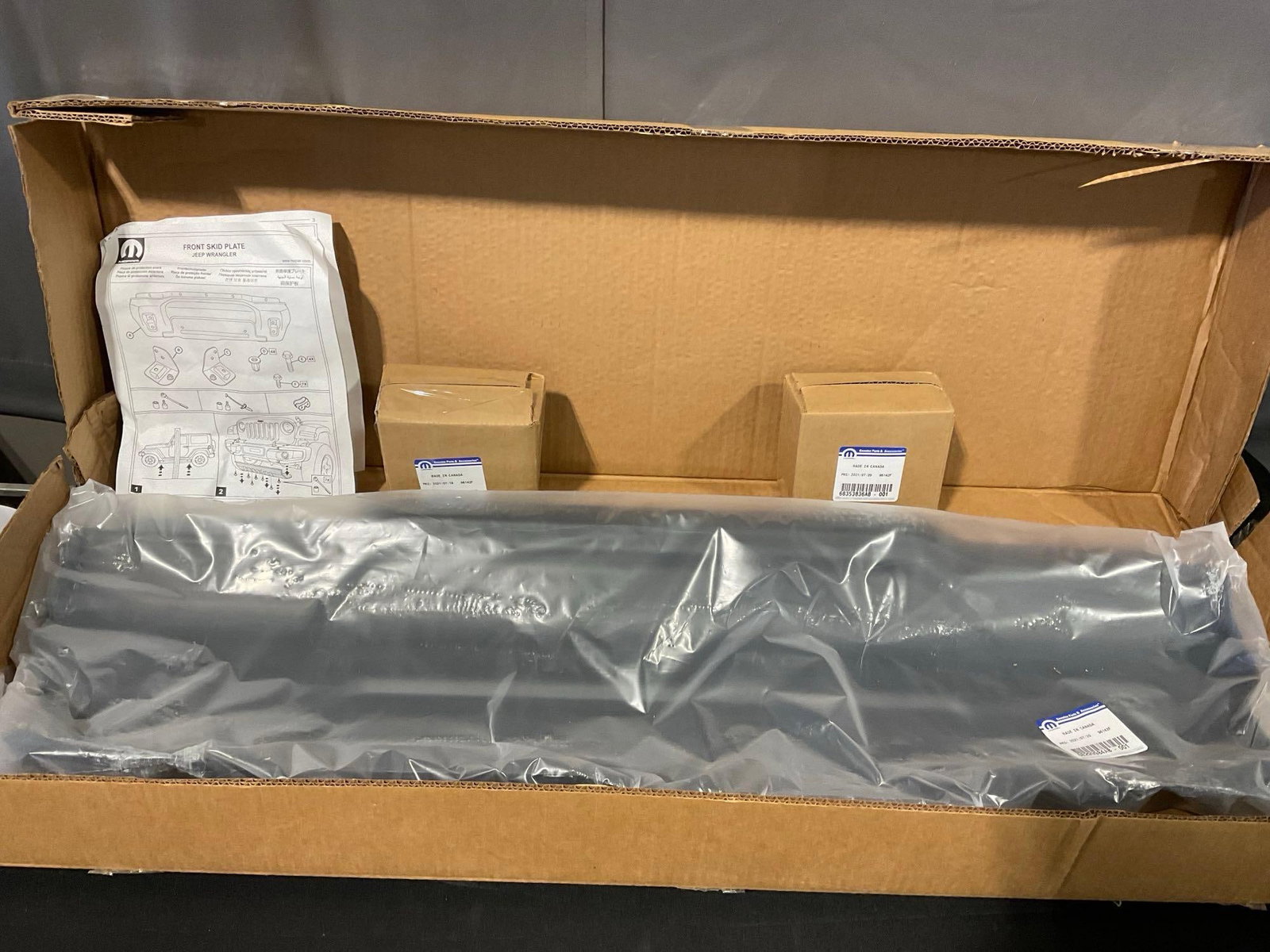 Mopar Front Skid Plate Jeep Wrangler, solid piece of metal, quite heavy, unopened in box:  Appears to be in good shape. The piece measures approx 6h x 43w x 15d inches. See pics. E-5910 *Freight Required if shipped, Buyer Arranged/Responsibility*