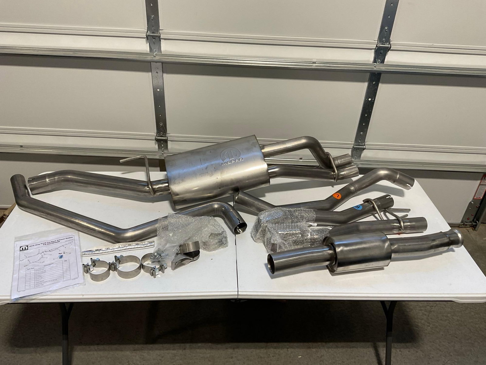 2019 Jeep Truck Cat-Back Exhaust System Muffler Assembly w/Tailpipes, NIB: Appears to be in good shape, came in box w/formed foam, was opened for pictures. The piece measures approx 18h x 61w x 21d inches. See pics. E-5910 *Freight Required if shipped, Buyer