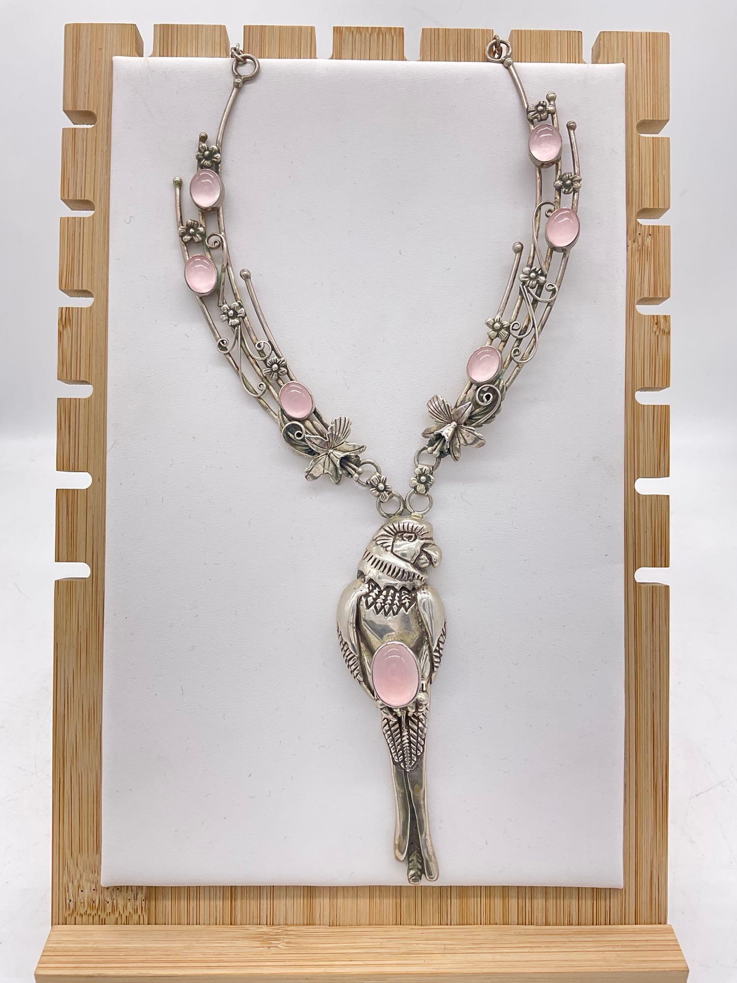 Sterling Silver Carol Felly SW Native Style Bib necklace w/ Parrot, Floral motif & Rose Quartz: Fantastic piece Studded with most likely Rose Quartz oval cabochons signed CF 1987 76.46 Grams 14" necklace w/ 4" Sterling Parrot CF is the hallmark for well respected Carol Felley, and is
