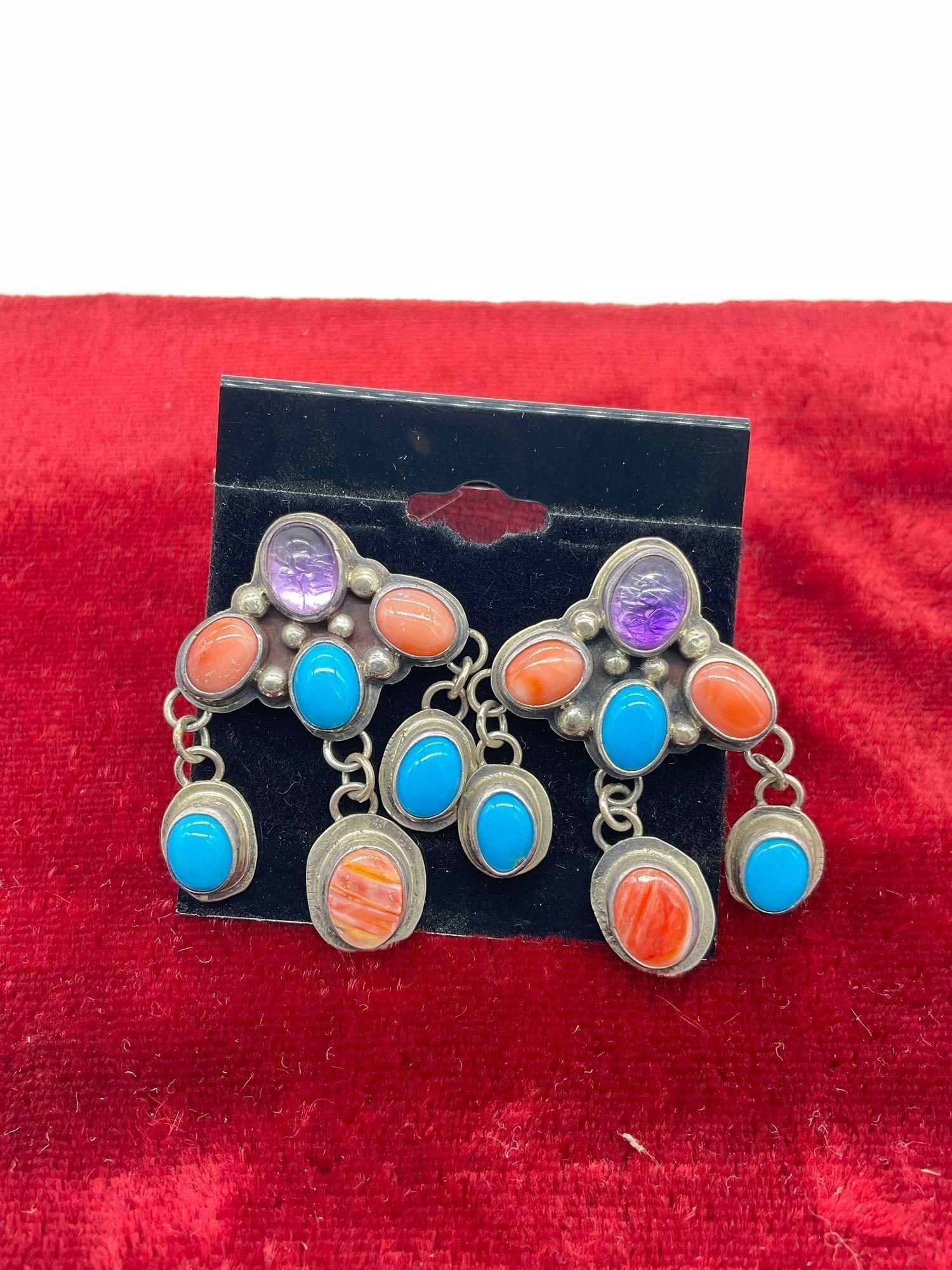 Pair of Signed Sw Native American Navajo earrings w/ Orange Oyster Shell, Amethyst, &Turquoise: Signed Nakai Nakai refers to several Navajo silversmiths, often working as a family , (Gilo & Grace Nakai ), known for classic Navajo styles like turquoise/coral inlay, stamped designs, and 