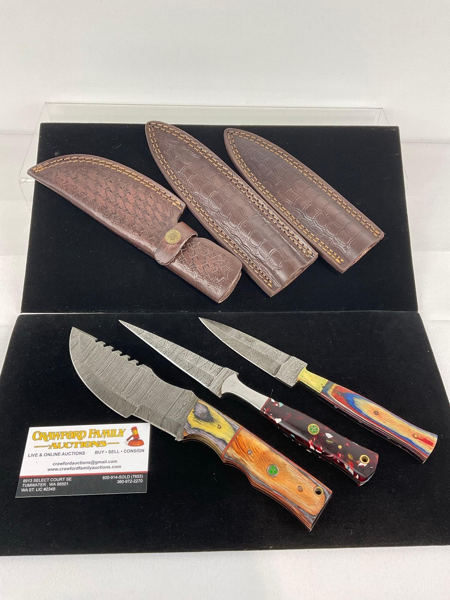 3 Handmade Knives, 1 Tracker & 2 Dagger w/Damascus style blades, Wood & Resin Handles, & Sheaths: Appears to be in good shape. The piece measures approx 12h x 5w x 3d inches. See pics. E-3440