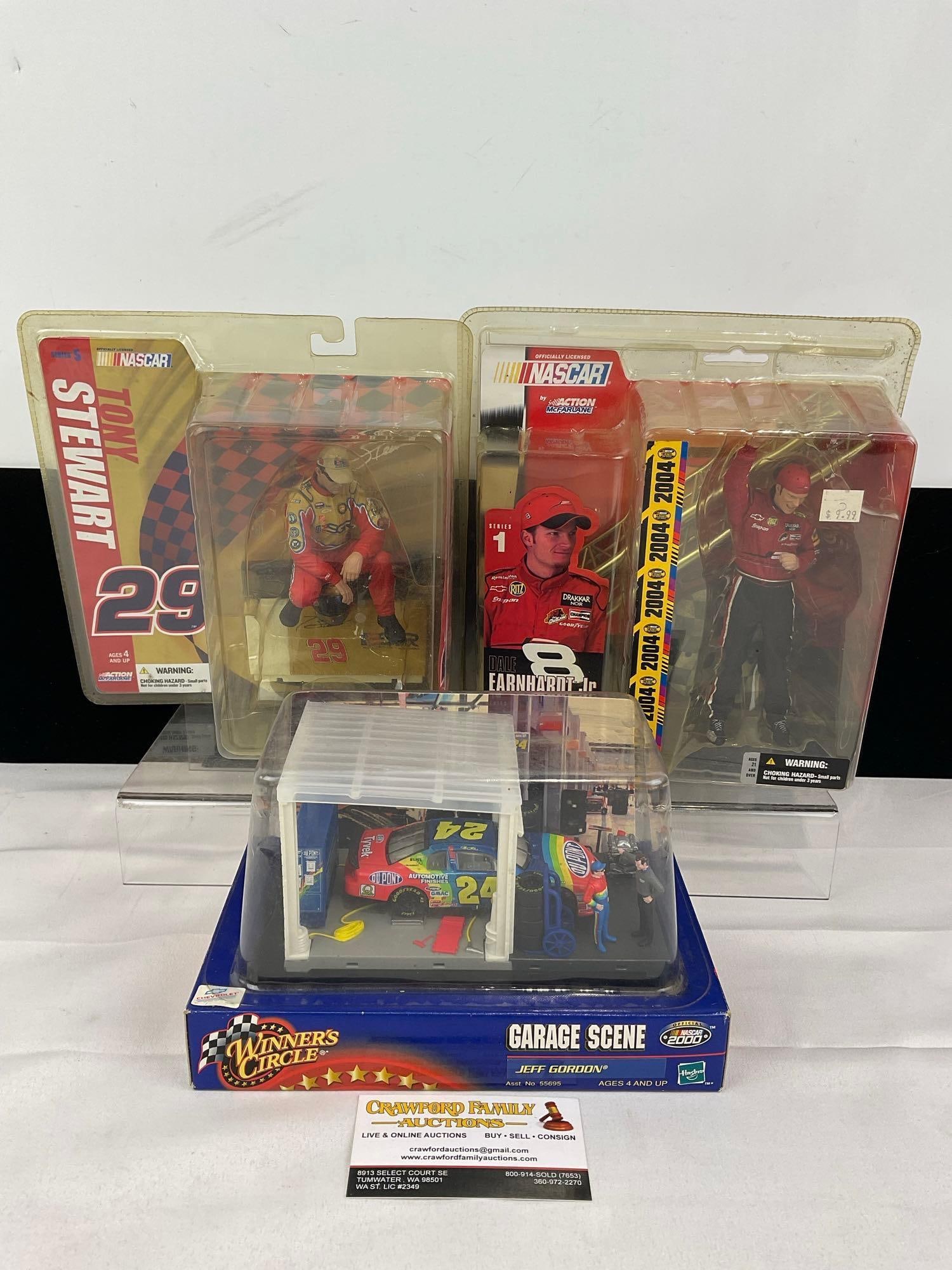 Pair of Nascar Driver Action Figures, #29 Tony Stewart & #8 Dale Earnhardt Jr. & Winners Circle...: #24 Jeff Gordon Garage Scene. Appears to be in good shape. The piece measures approx 11h x 12w x 9d inches. See pics. E-5940