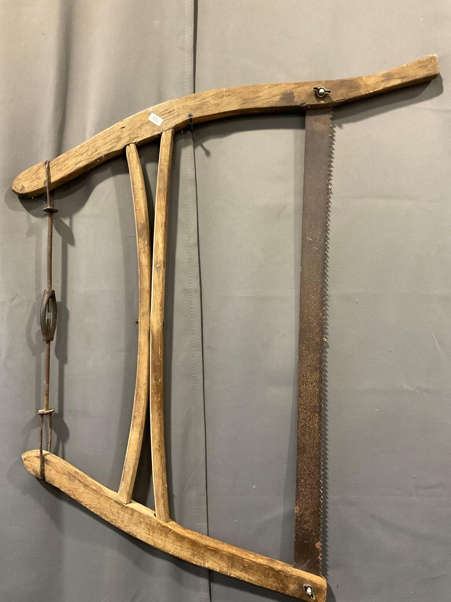 Antique Primitive style Buck/Bow Cross Cut Hand Saw, 25 x 34 inches: Appears to be in good shape, some signs of wear. The piece measures approx 25h x 34w x 4d inches. See pics. E-5880 *Oversized shipping may apply*