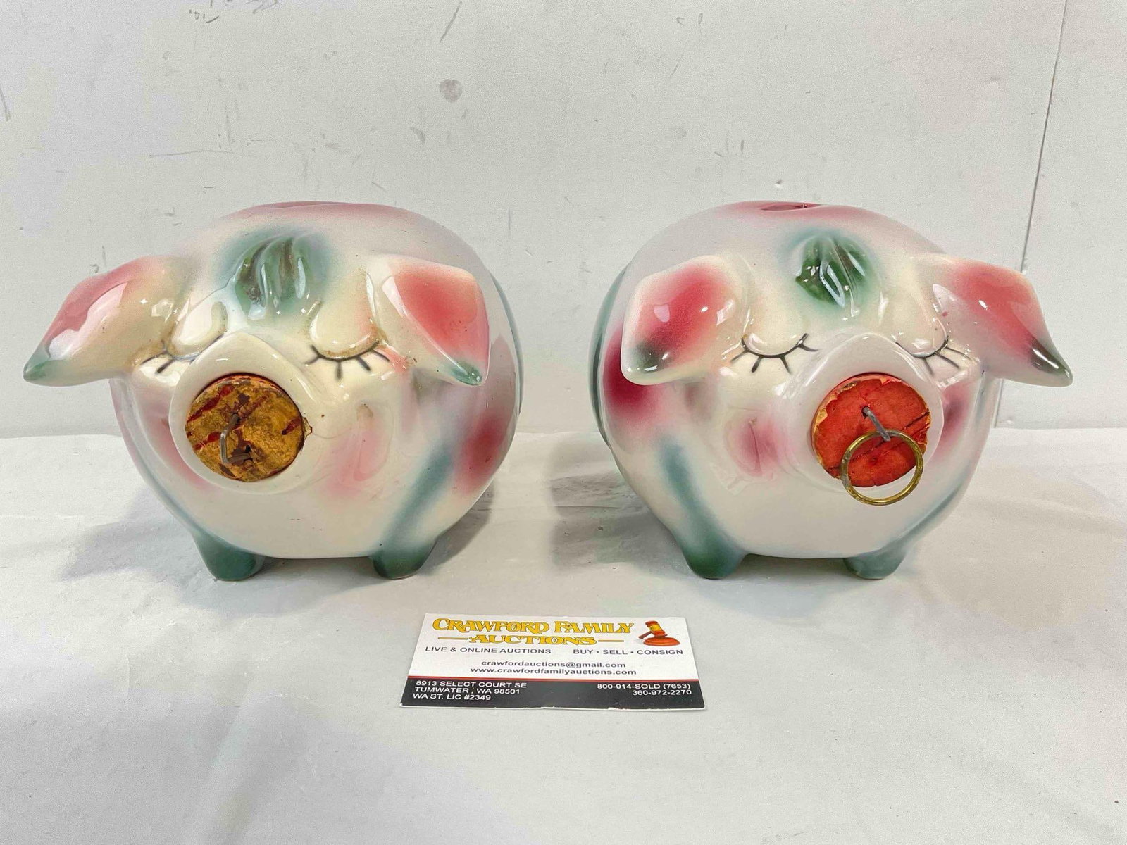 2 pcs Vintage Hull Corky Pig Ceramic Piggy Banks w/ Corks in Purple/Pink/Green Color Way.: 2 pcs Vintage Hull Corky Pig Ceramic Piggy Banks w/ Corks in Purple/Pink/Green Color Way. One has a cracked nose, the same pig's has some scattered marks, otherwise pieces look to be in fair