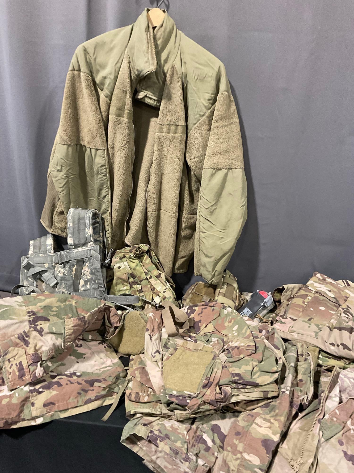 Asst Milsurp, few Advanced Combat Shirts 2XL size, ECWCS Pants & Shirt, 3 Camo NATO Jackets: Appears to be in good shape. The piece measures approx 15h x 29w x 20d inches. See pics. E-5880