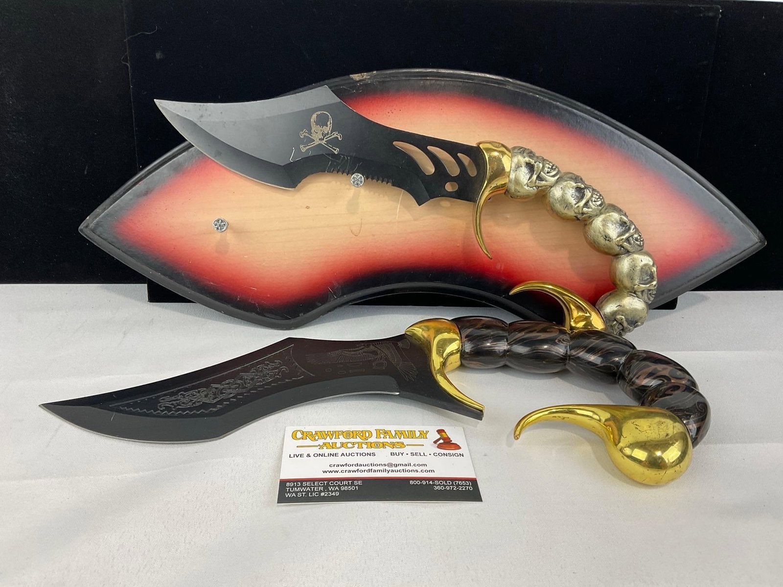 Pair of Egyptian Scorpion Tail Fantasy Knives, Skull Handle, w/1 Plaque: Appears to be in good shape. The piece measures approx 7h x 17w x 4d inches. See pics. E-5940