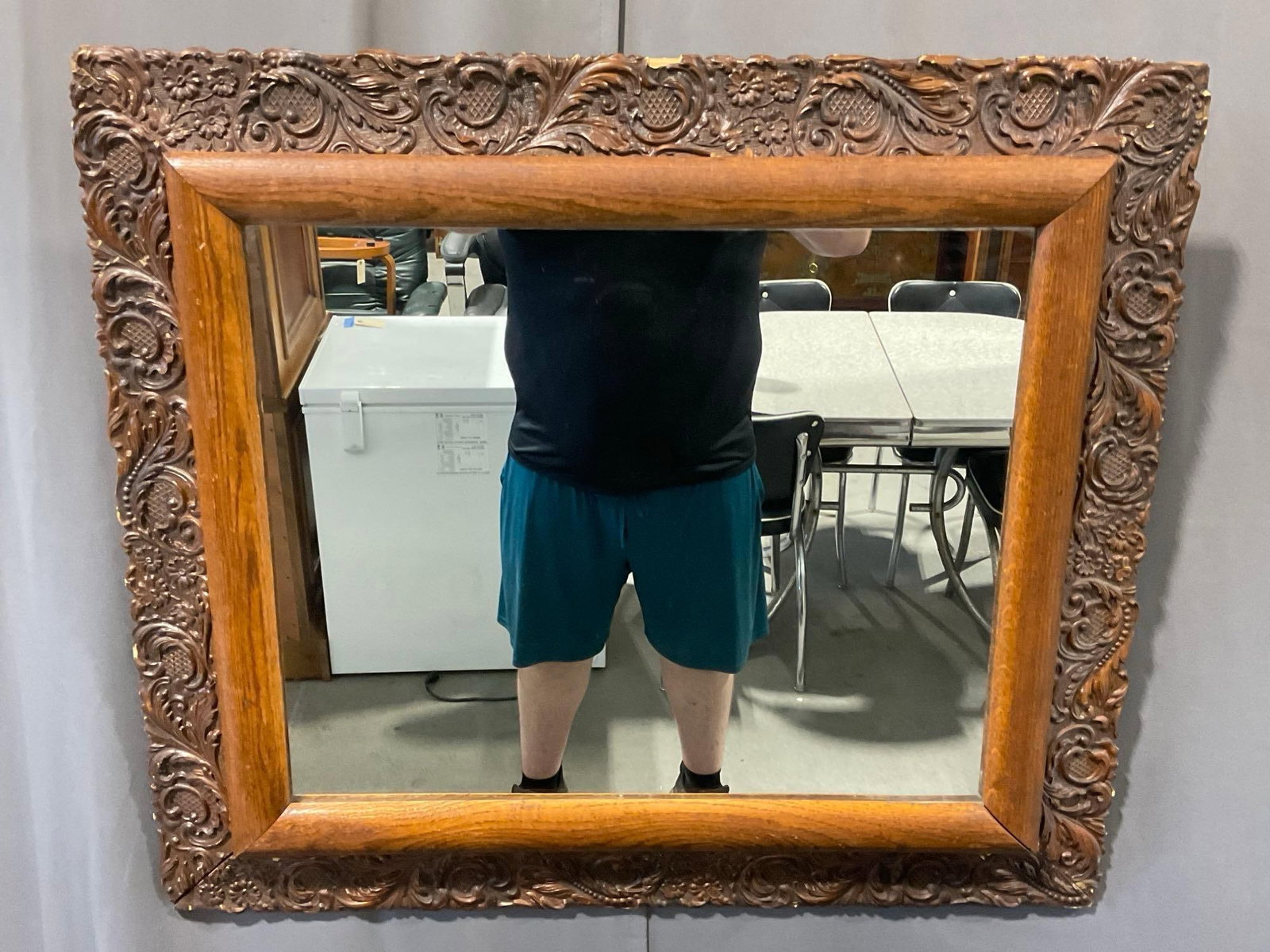 Antique Framed Mirror, scrollwork & floral detail + Oak frame, 29h x 33w x 5d inches: Outside edge is heavily detailed, the inside is quite simple oak or similar wood. Appears to be in fair to good shape, some wear or broken edges on the frame. The piece measures approx 29h x 33w x 5d