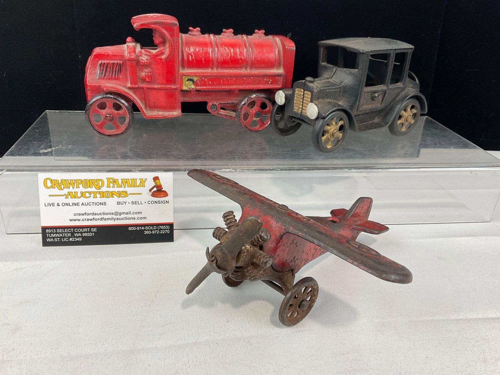 Cast Iron Toys, Red Hubley Fire Truck, Black Model T Coupe, & Red Plane: Appears to be in good shape. The piece measures approx 4h x 10w x 7d inches. See pics. E-5950