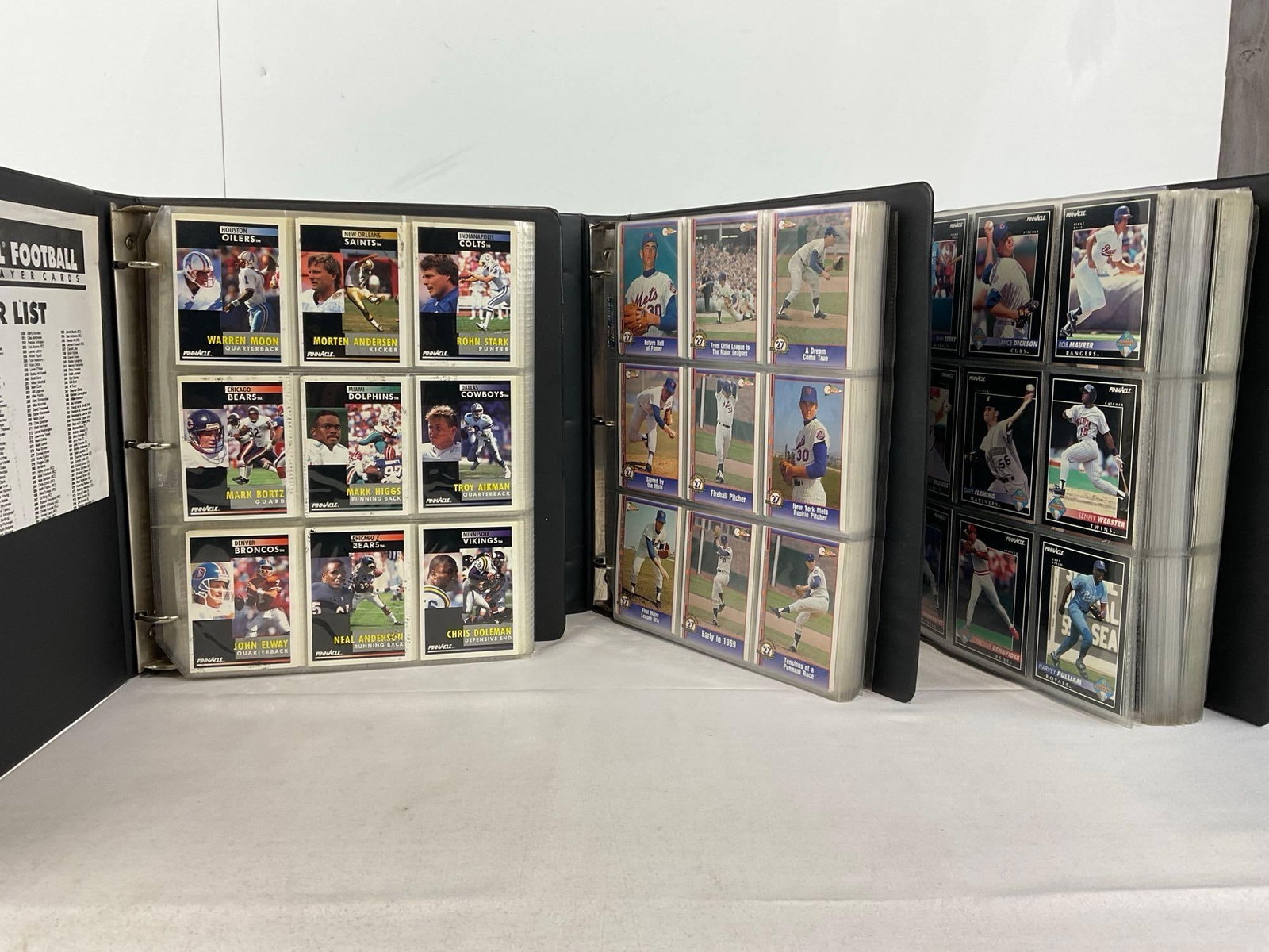 3 Binders of Cards, Pinnacle 90s Baseball Football , & 1991 Pacific Nolan Ryan Texas Express Binder: Appears to be in good shape. The piece measures approx 7h x 13w x 13d inches. See pics. E-5940