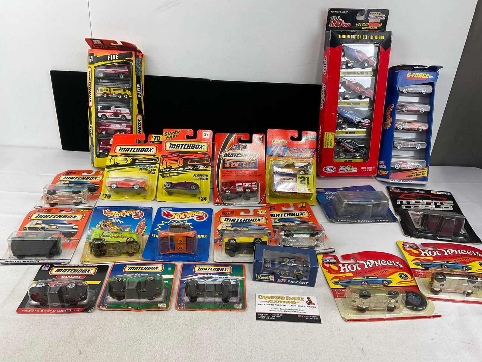 31 Diecast Cars, Matchbox, Hot Wheels, & Racing Champions, in packaging: Appears to be in good shape. The piece measures approx 9h x 17w x 14d inches. See pics. E-5940