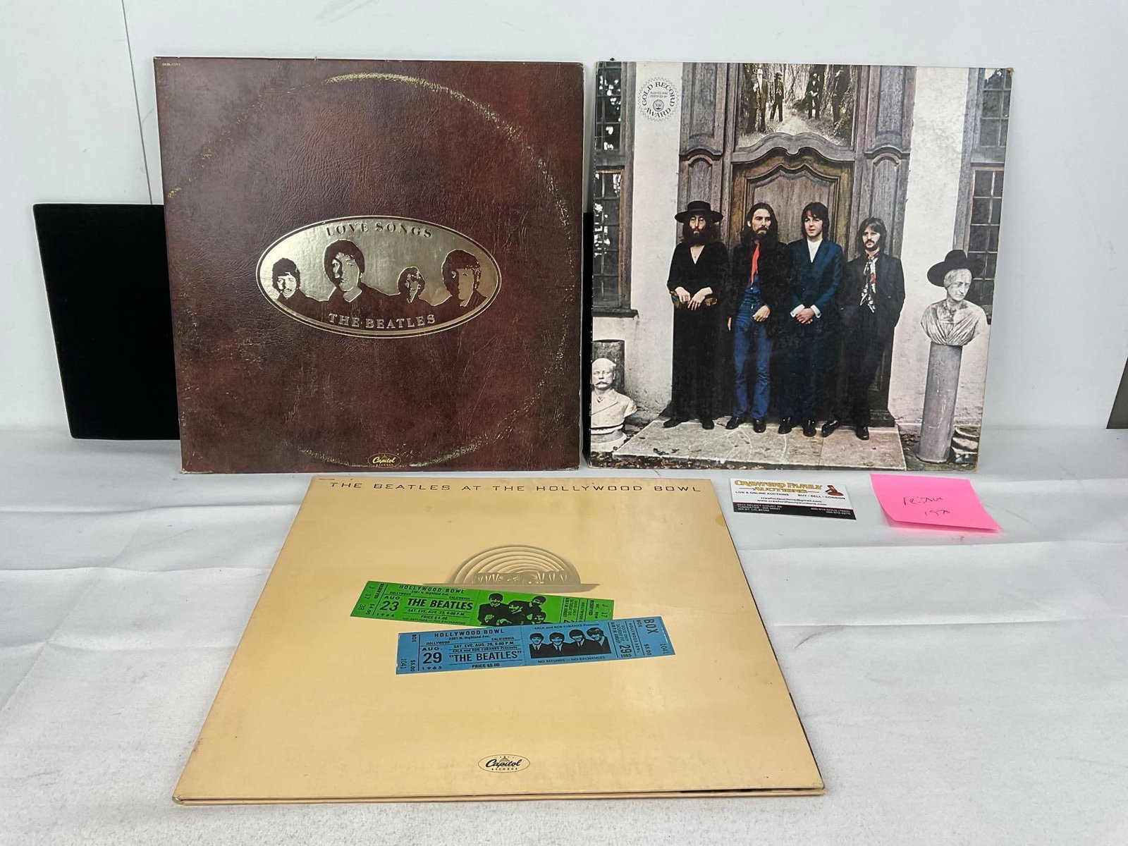 Trio of Beatles Vinyl Records, Love Songs, Hey Jude & Hollywood Bowl 1964 & 65: The one looks to be a reissue from 1976, the other two are from 1977, we are not experts on records. Appears to be in good shape. The piece measures approx 2h x 14w x 14d inches. See pics. E-5950