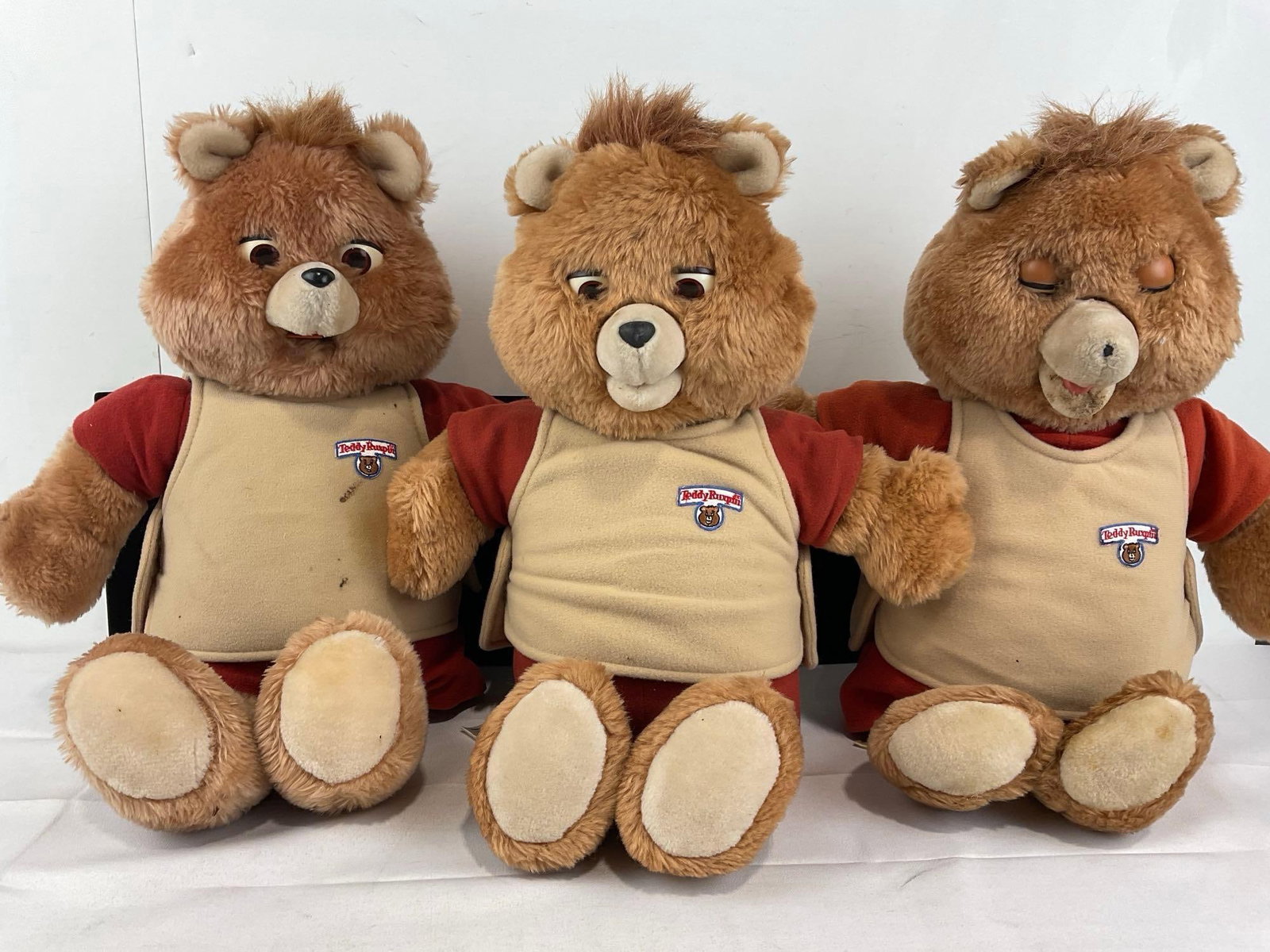 3 Teddy Ruxpin Bears, Plush Toys, w/Cassette Players, w/Tape The Airship, some wear: Appears to be in fair to good shape, the electronics are untested, assumed working, one of the battery compartment is corroded. The pieces fit in a a tub that measures approx 11h x 19w x 16d inches. S