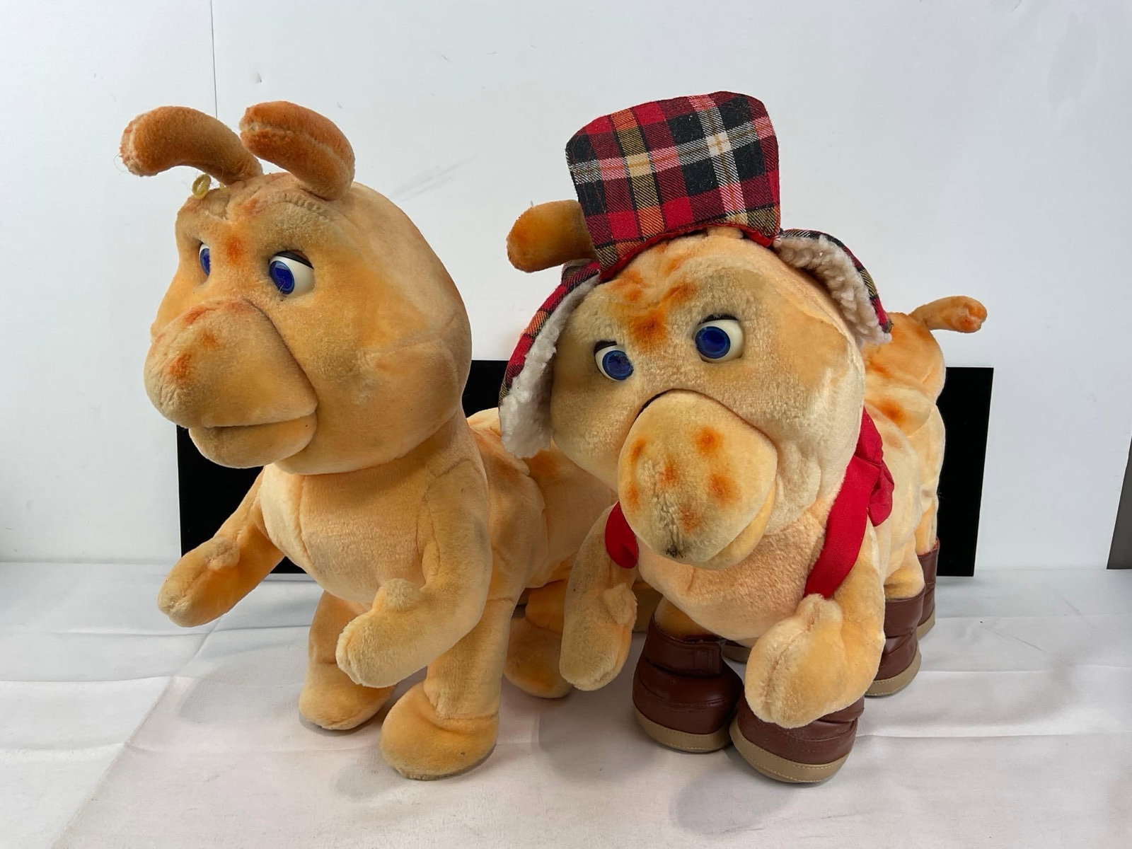 Pair of Teddy Ruxpin Grubby Plush Dolls, 1 w/clothes & shoes, some wear: Appears to be in fair to good shape, the electronics are untested, assumed working, one has corroded batteries in the compartment. The pieces fit in a a tub that measures approx 21h x 14w x 14d