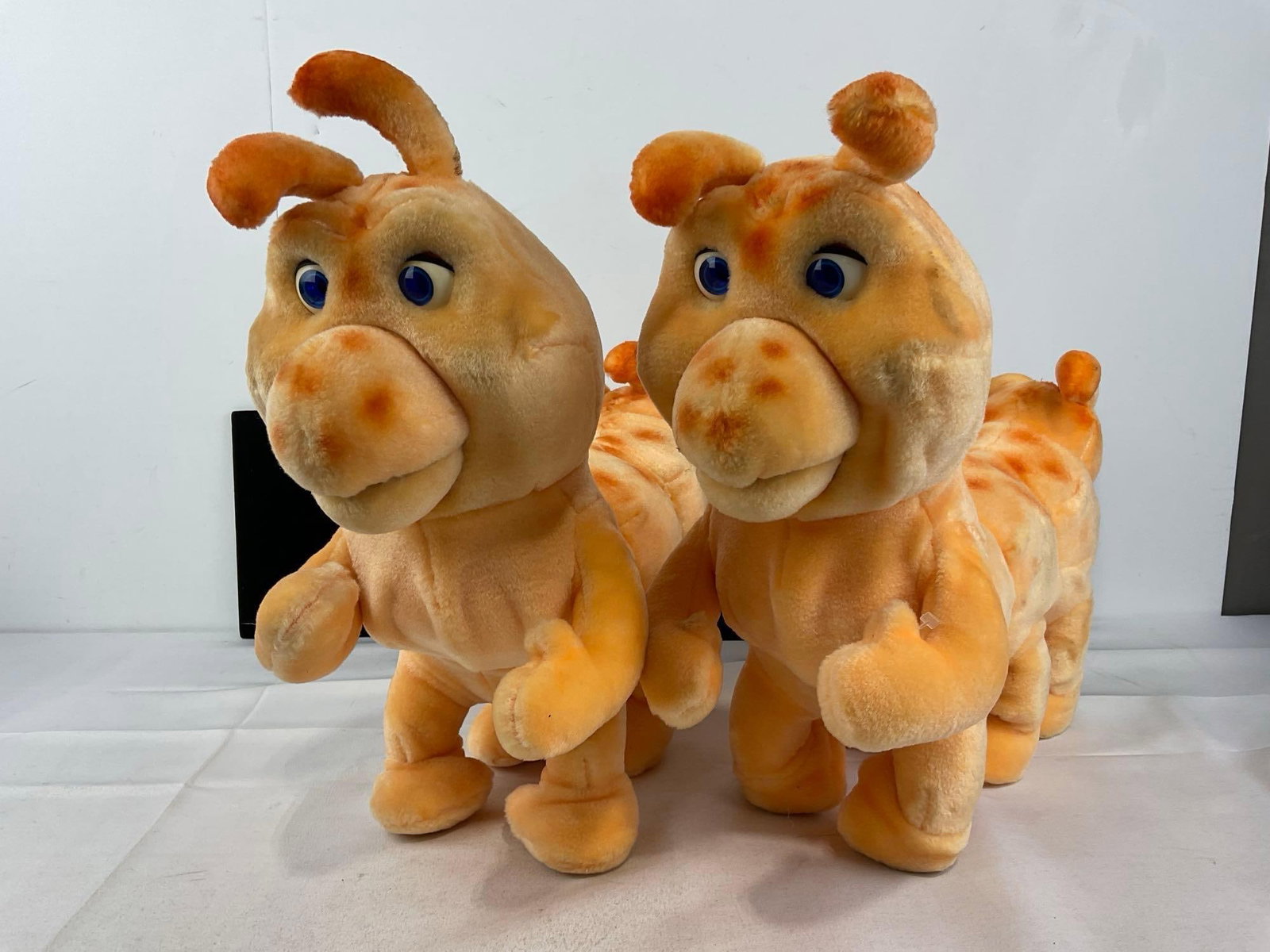 Pair of Teddy Ruxpin Grubby Plush Dolls, some wear: Appears to be in fair to good shape, the electronics are untested, assumed working, one has corroded batteries in the compartment. The pieces fit in a a tub that measures approx 21h x 14w x 14d