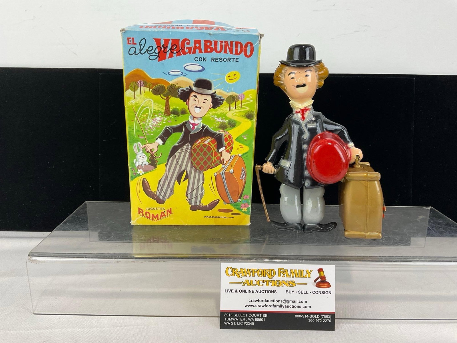 Vintage 1960s The Happy Vagabond Wind-Up Charlie Chaplin Toy, made in Spain by Juguetes Roman w/box: Marked El Alegre Vagabundo Con Resorte. The box has some wear, but otherwise in good shape. The toy appears to be in good shape, may have some wear from over the years. The piece measures approx 8h x