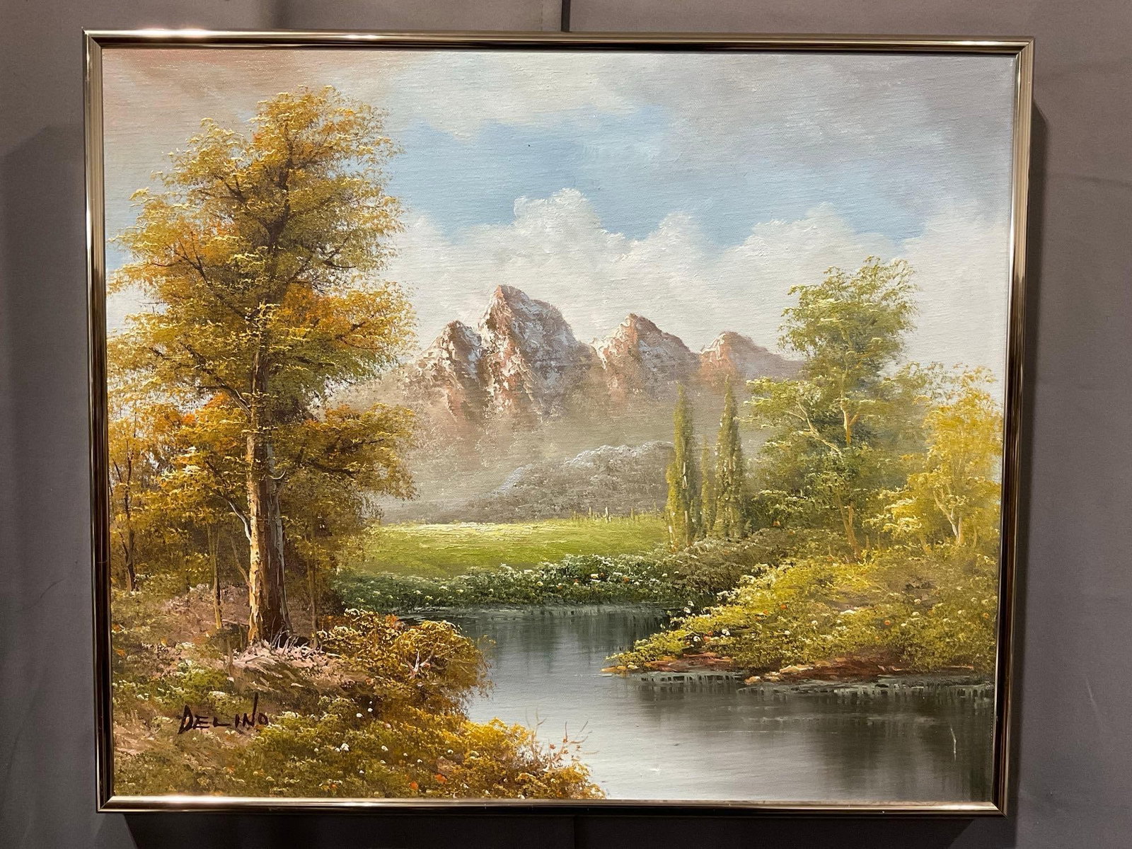 Framed Oil on Canvas, Calm River, w/Mountains in background, signed Delino, 22h x 25w x 3d inches: Signature in the bottom left. Appears to be in good shape. The piece measures approx 22h x 25 x 3d inches. See pics. E-6080