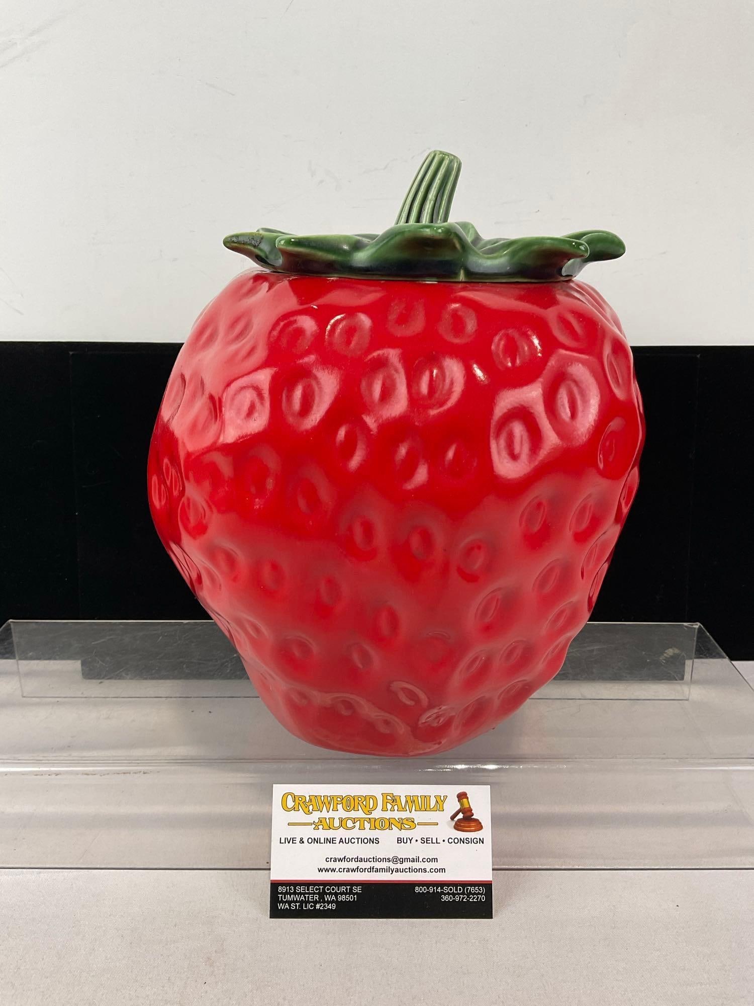 Early 20th Century McCoy Strawberry Shaped Cookie Jar, w/green stem Lid, 10h x 8w x 9d inches: Appears to be in fair to good shape, some wear around the edge of the rim. The piece measures approx 10h x 8w x 9d inches. See pics. E-5950