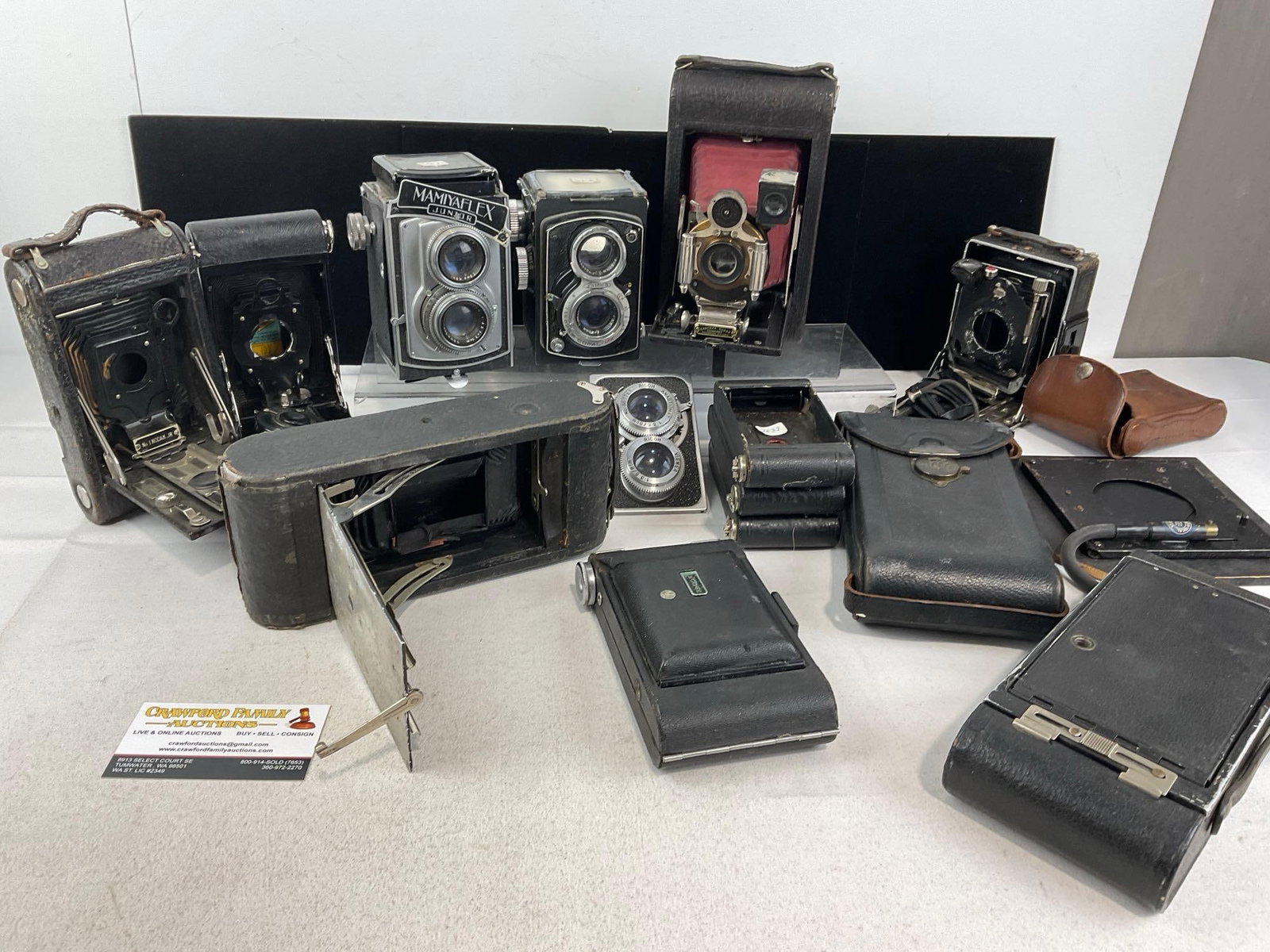 Selection of Vintage Cameras, some wear, and some missing pieces, Mamiya Flex JR, Eastman Kodak C...: lots more, 3 cases, no internals, a few cameras w/no lenses, Eastman Kodak Co. Automatic, Yashica double lens. Appears to be in fair shape. The piece measures approx 4h x 16w x 14d inches. See pics. E