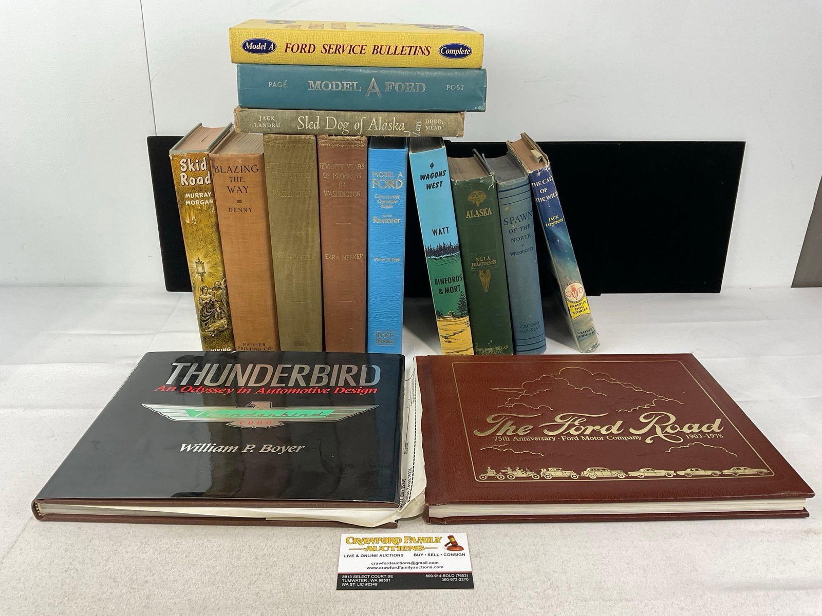 14 Vintage Books, Lots of Ford Thunderbird, Model A, Service Bulletins: Seventy Years of Progress in Washington. Skid Road, Blazing the Way, Alaska, 4 Wagons West, Spawn of the North, The Call of the Wild. Appears to be in good shape. The piece measures approx 10h x 16w