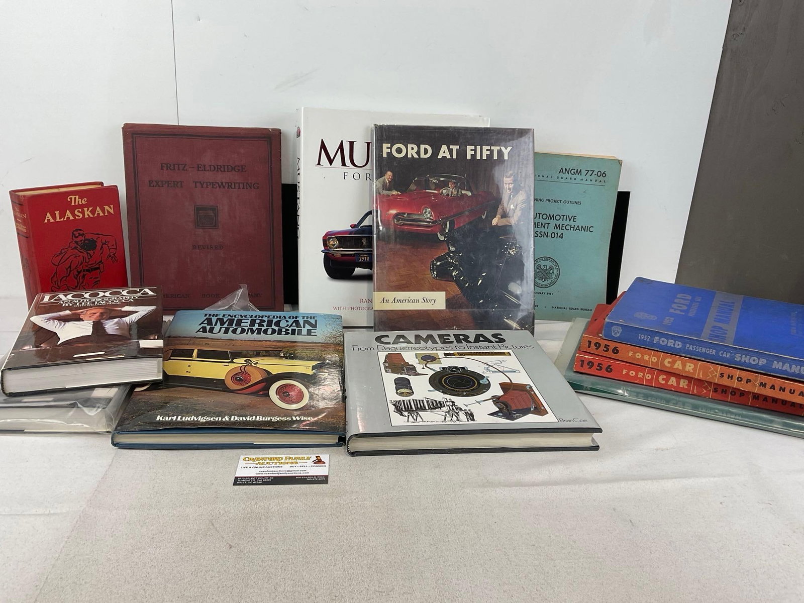 Several Ford & Car Books, 2x Iacocca Biography, Ford at Fifty, Mustang 40 Years, 1950s Car Manual...: The Encyclopedia of the American Automobile, The Alaskan, Cameras, From Daguerrotypes to Instant Pictures. & more. Appears to be in good shape. The piece measures approx 12h x 16w x 14d inches.