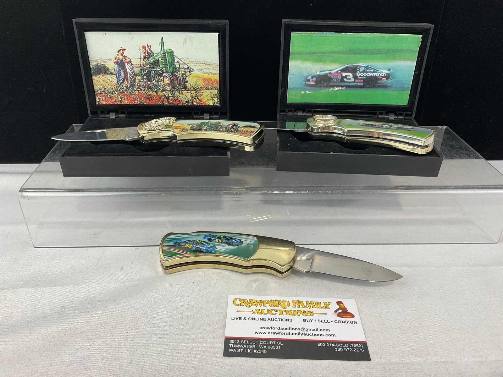 Set of 3 Commerorative Knives, Racing Scenes on 2 & John Deere Tractor, w/2 cases: Appears to be in good shape. The piece measures approx 4h x 6w x 4d inches. See pics. E-5940
