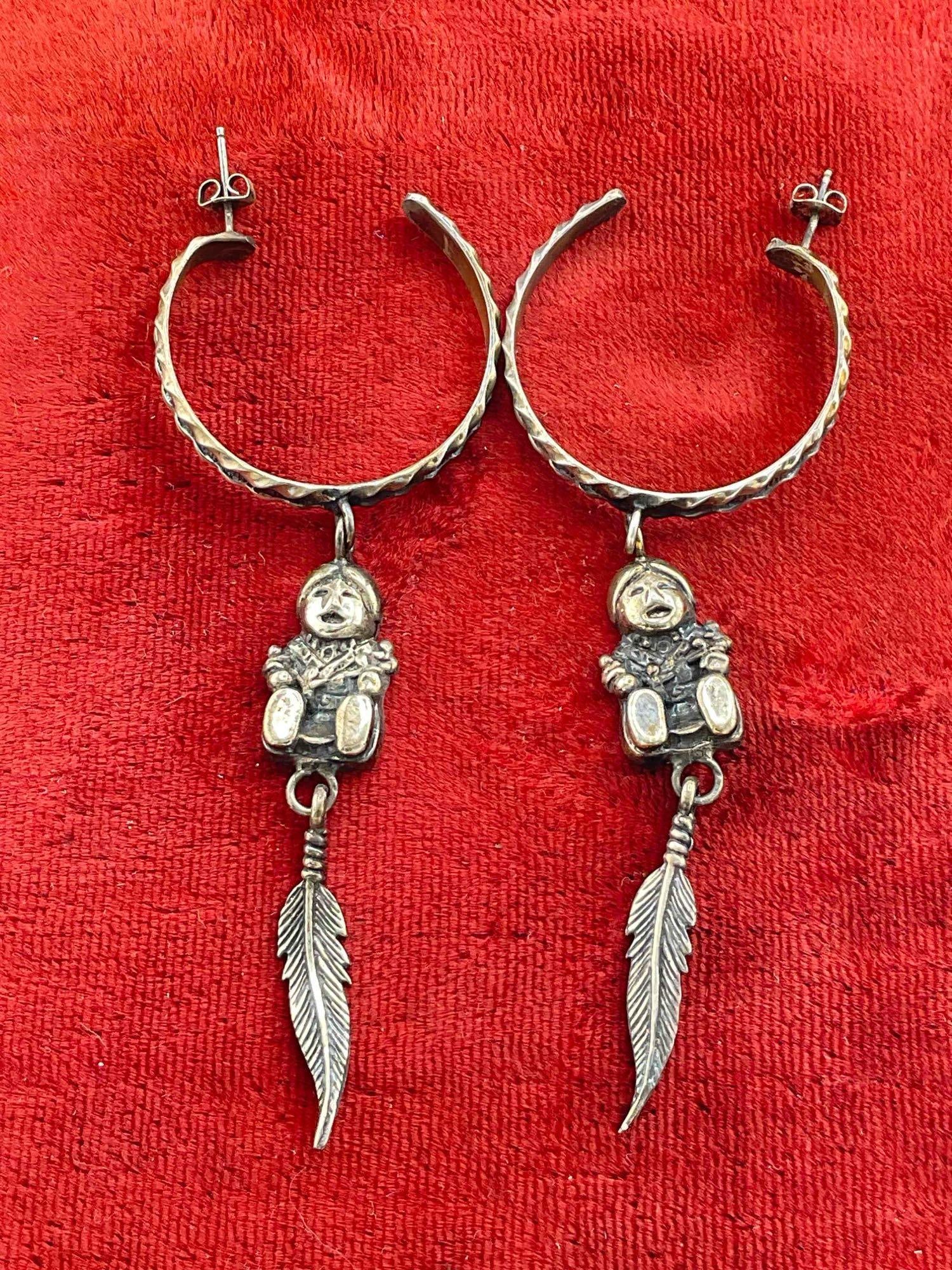 Vintage Carol Felley Sterling Silver Hoop Earrings w/ Storyteller & Feather Dangle Design.: Vintage Carol Felley Sterling Silver Hoop Earrings w/ Storyteller & Feather Dangle Design. Stamped '91 on reverse. Weighs 22g for the pair. DM-414