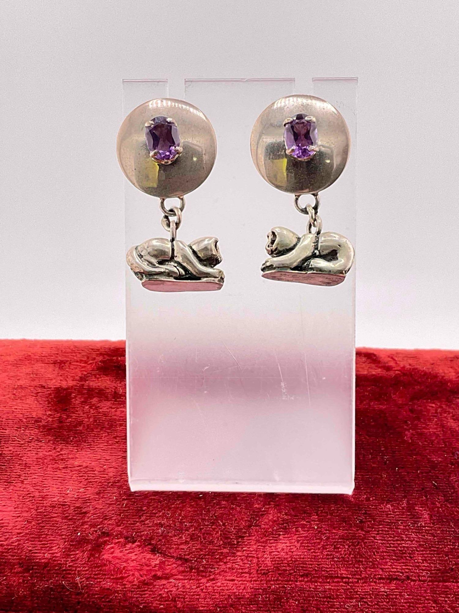 Vintage Carol Felley Sterling Silver Earrings w/ Amethyst Toned Setting & Cat Design. See pics.: Vintage Carol Felley Sterling Silver Earrings w/ Amethyst Toned Setting & Cat Design. Stamped 91 on reverse. Weighs 17 grams. DM-414