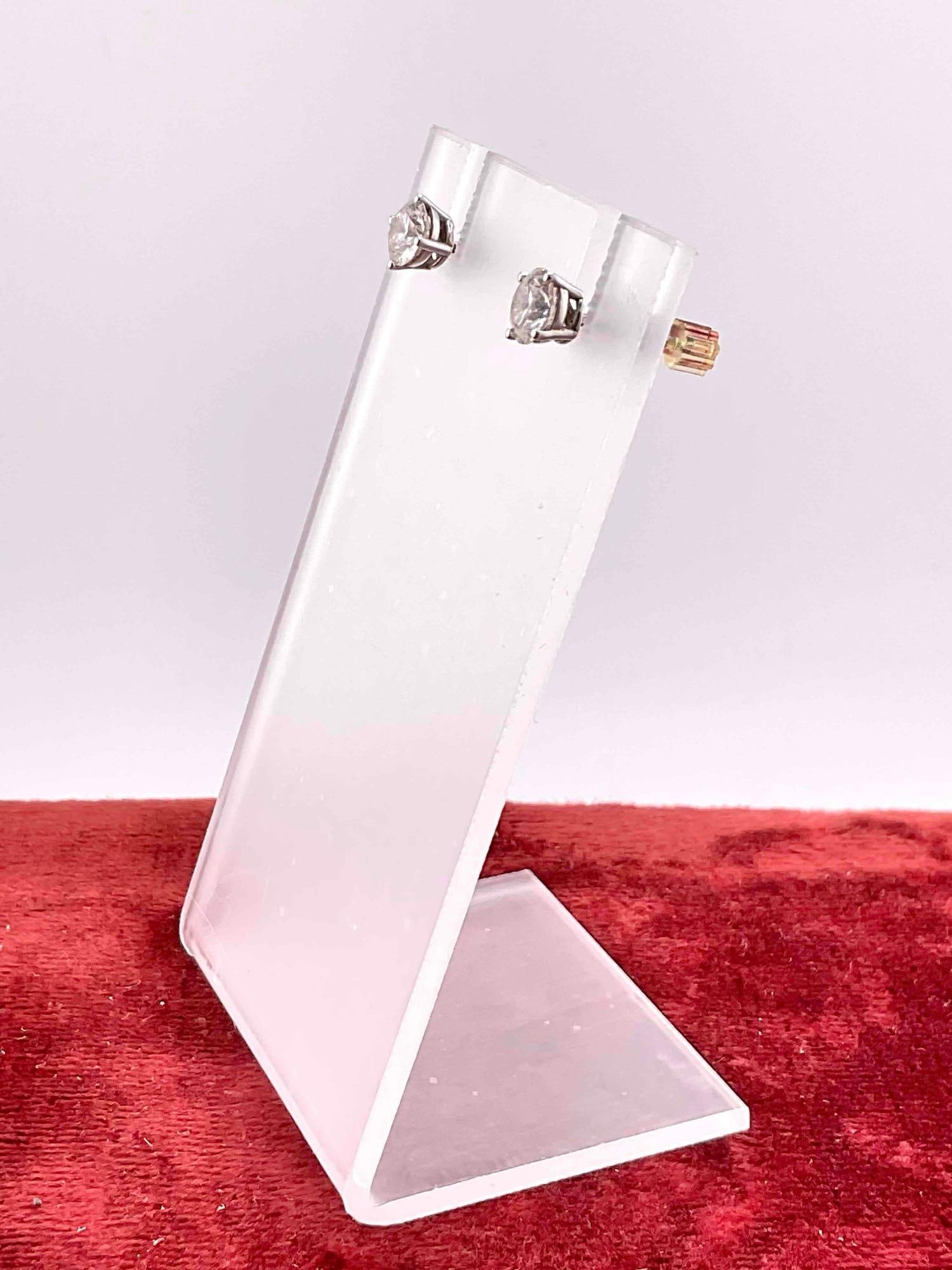 Pair of 14K white gold post earrings, each earring features a Brilliant .70ct round cut diamond - 2