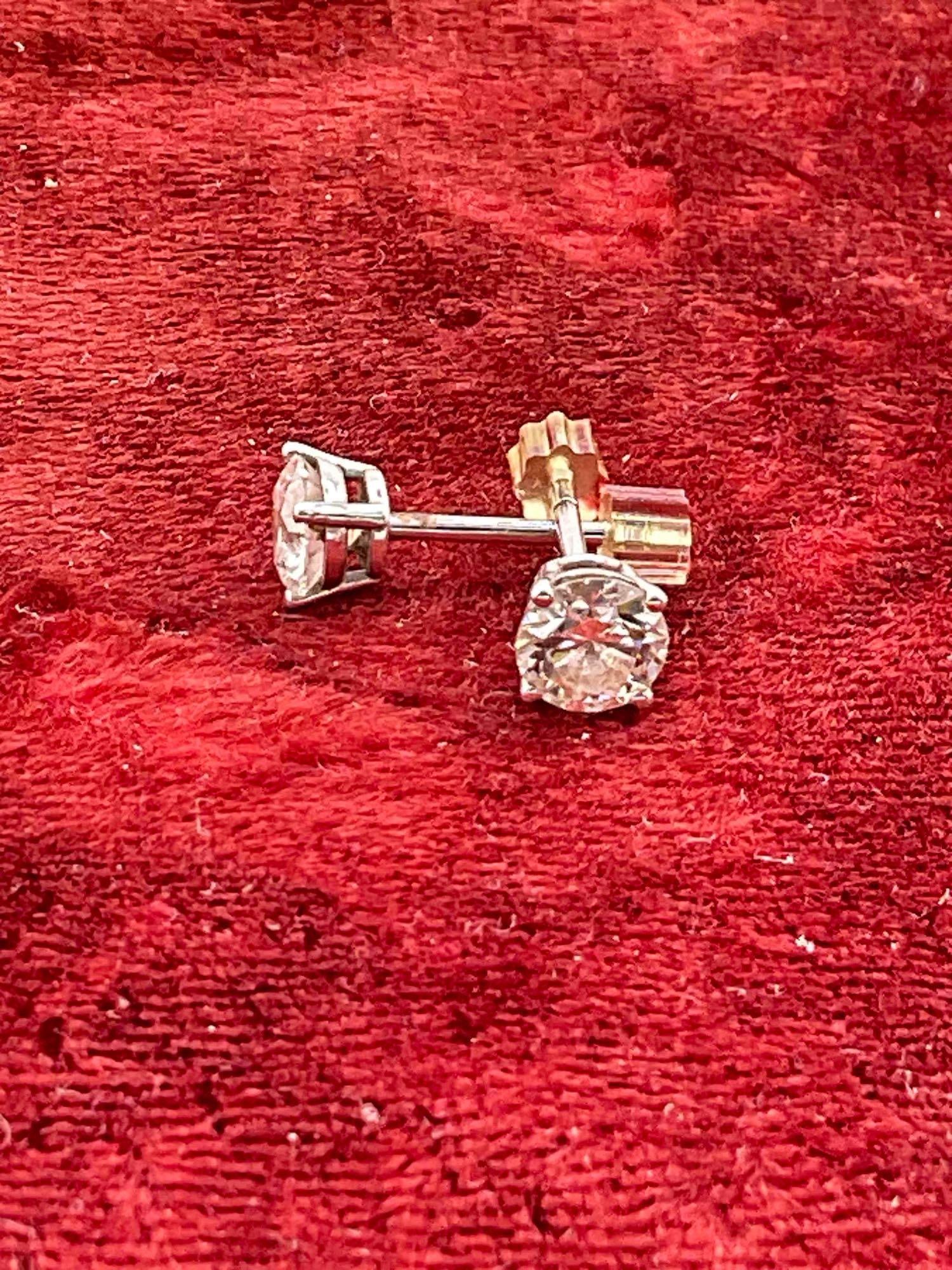 Pair of 14K white gold post earrings, each earring features a Brilliant .70ct round cut diamond - 3