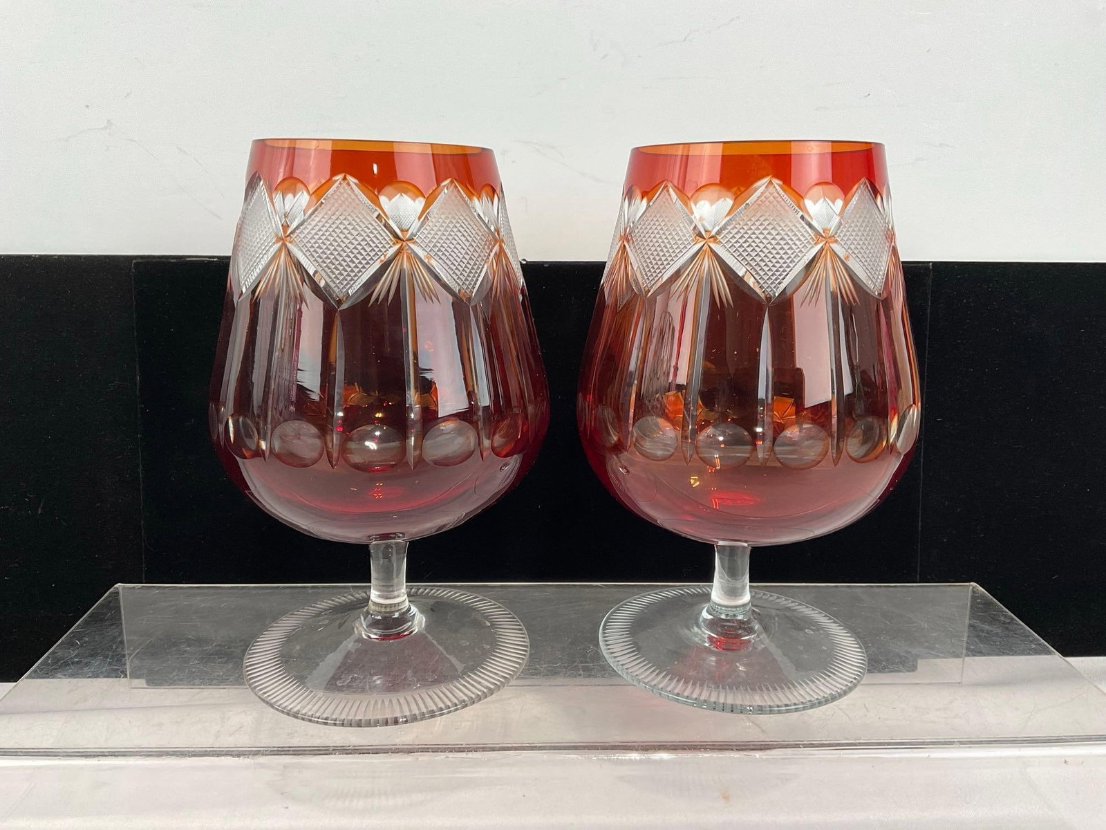 Pair of Bohemian Remery Kristall Cognac Snifter Red, Cut to Clear Glasses: Appears to be in good shape. The piece measures approx 12h x 14w x 10d inches. See pics. E-6080