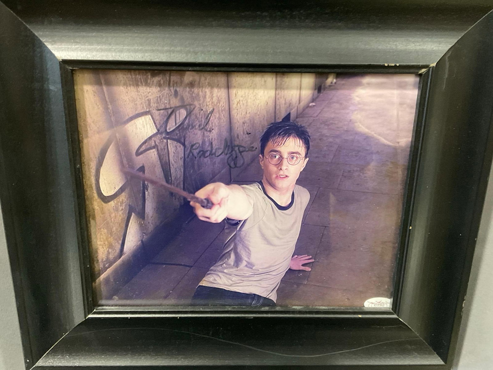Framed Picture signed by Daniel Radcliffe as Harry Potter from Harry Potter films, 13x11 inches: This from the collection of the late owner of a signed items collection store. Appears to be in good shape. The piece measures approx 13h x 15w x 3d inches. See pics. E-6220