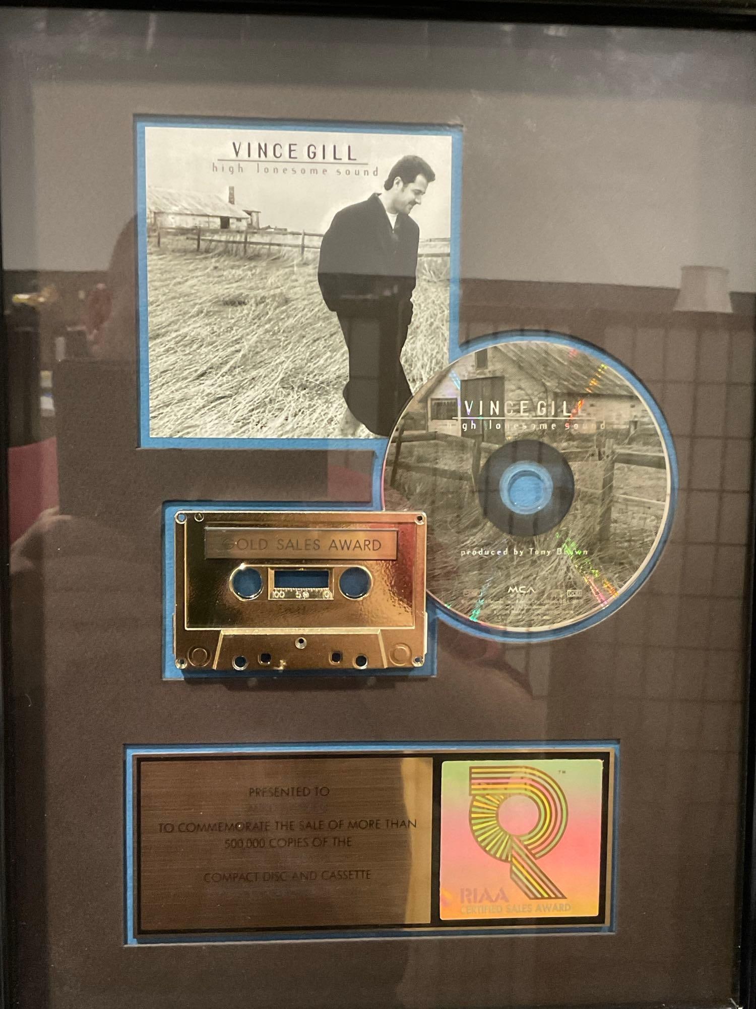 Framed Shadowbox, Vince Gill RIAA High Lonesome Sound, MCA Records Gold Sales Award, 18x14 inches: This from the collection of the late owner of a Collection Store.this piece was made for 500,000 Copies of CD & Cassette Sales from MCA Records. Appears to be in good shape. The piece
