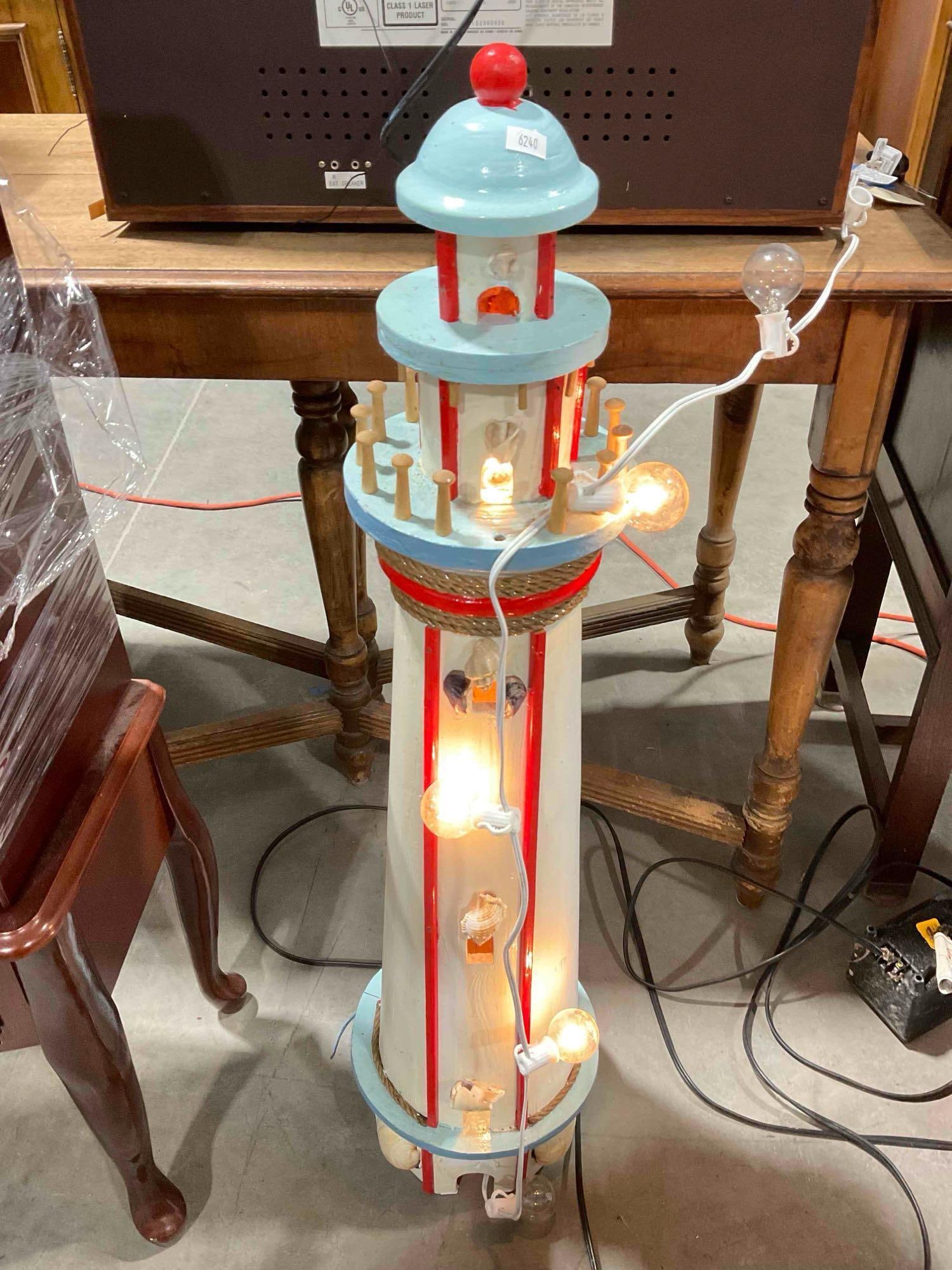 Custom Built Blue/White/Red Painted Wooden Lighthouse Yard Art w/ String of Lights. See pics.: Custom Built Blue/White/Red Painted Wooden Lighthouse Yard Art w/ String of Lights. Some lights are missing, piece has signs of being outside, otherwise looks to be in fair condition. Measures 10" x