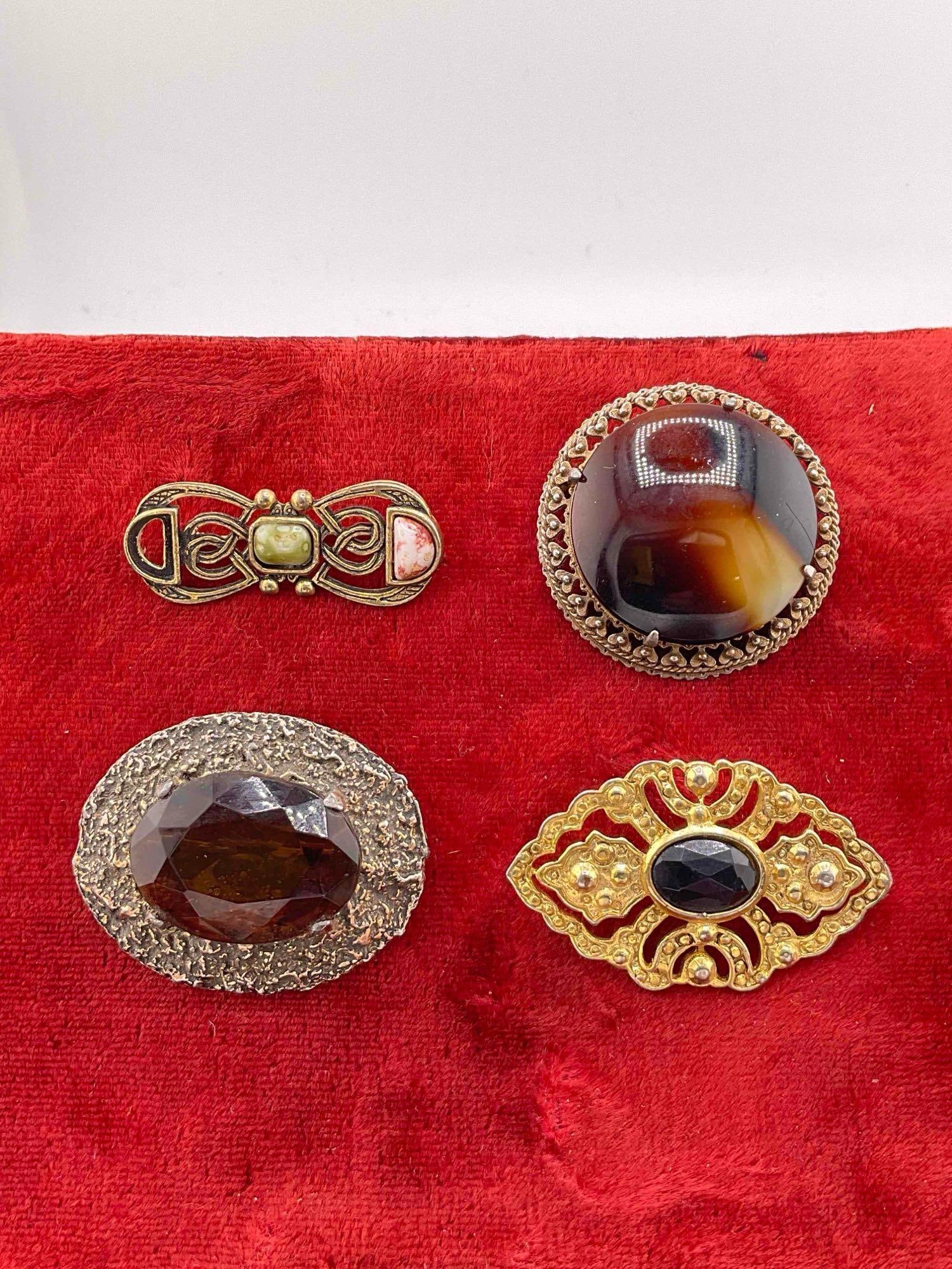 4 x Vintage gold and silver toned MC Brooches/ pins w/ various stones & polished cabochons: c-6110 the smaller brooch is missing 1 stone 