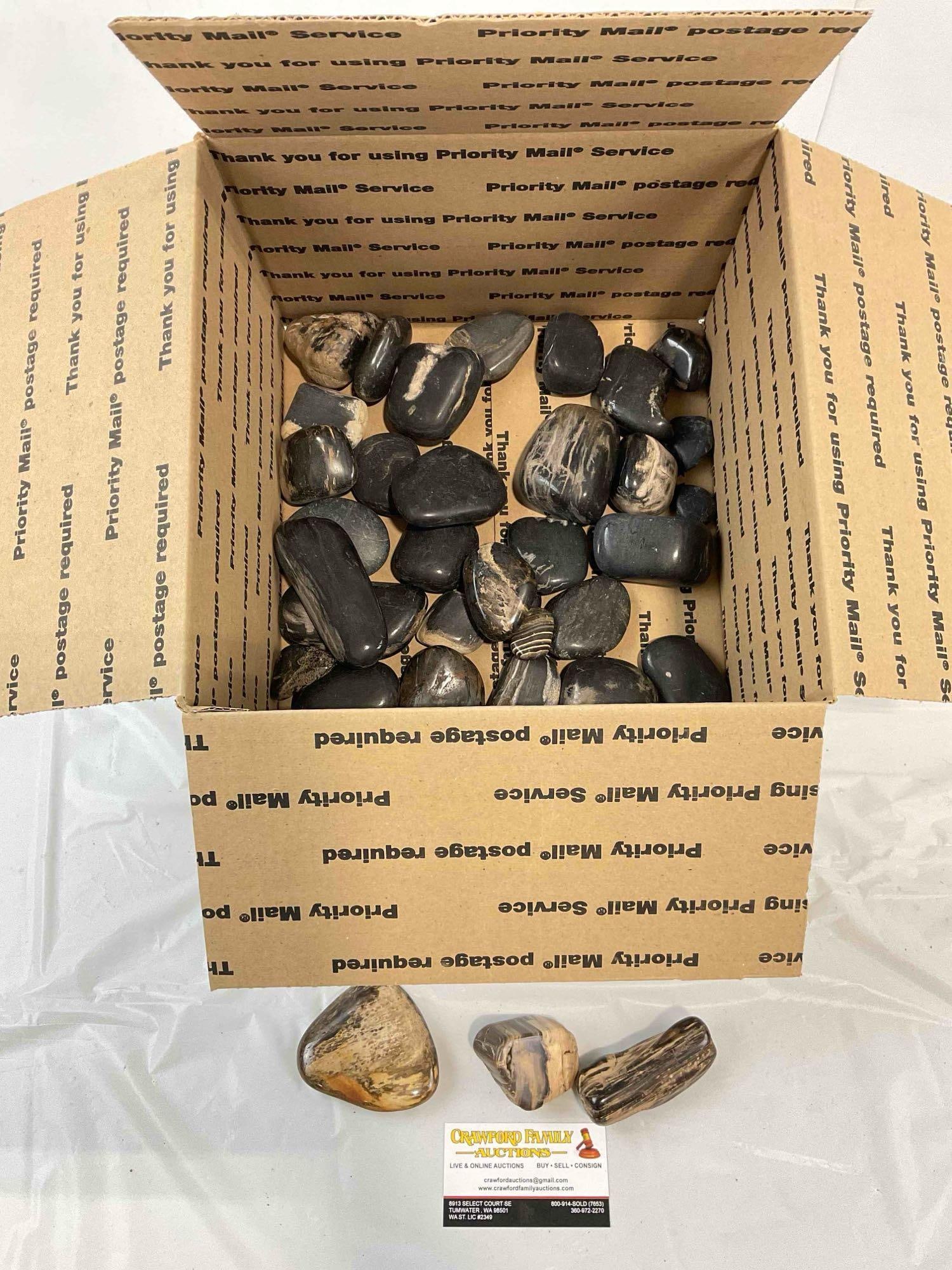 Uncounted Assortment of Tumbled Black River Rocks & Petrified Wood. Good Condition.: Uncounted Assortment of Tumbled Black River Rocks & Petrified Wood. Good Condition. Looks to be in good condition. Fits in box measuring 12" x 12" x 6" DM-6030