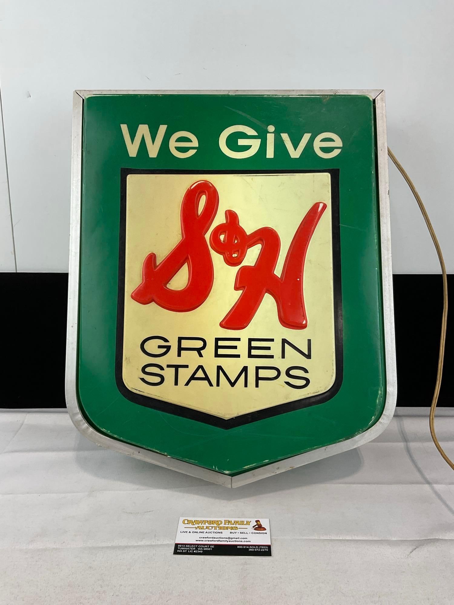 Vintage S&H We Give Green Stamps Lighted Hanging Sign, 18x15x6 inches, tested & working: American Sign Company. Appears to be in good shape, some finish wear. The piece measures approx 18h x 15w x 6d inches. See pics. E-6120