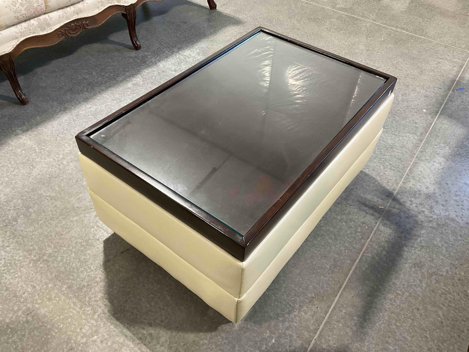 Modern Glass Topped Coffee Table w/ Wood & Cream Vinyl Base. Measures 35" x 23" x 17" - 4