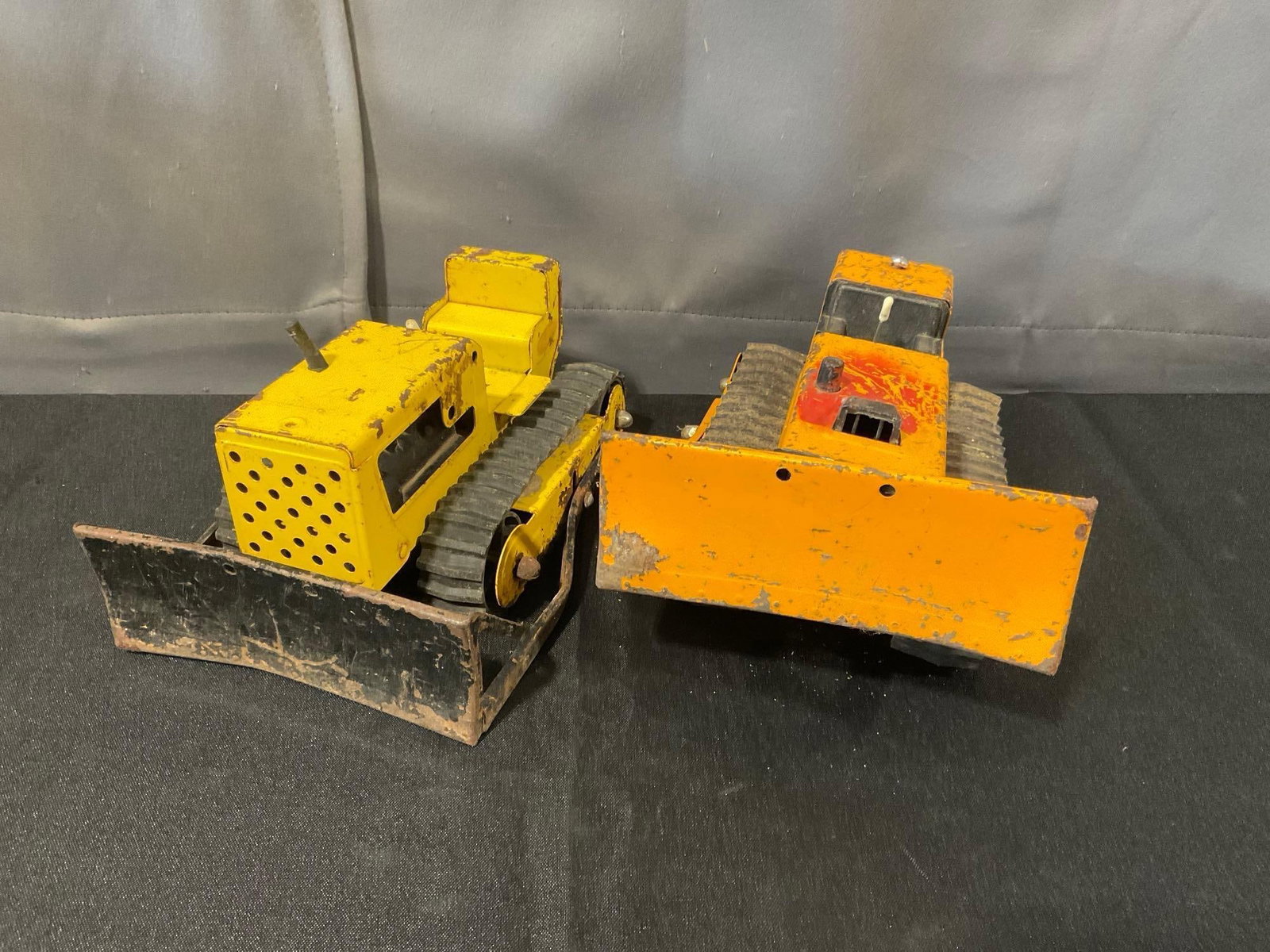 Pair of Pressed Steel Tonka Bulldozers, 50s-60s piece & T-6 Tracked Bulldozer from mid-1970s: Appears to be in fair to good shape. The piece measures approx 10h x 7w x 10d inches. See pics. E-6300
