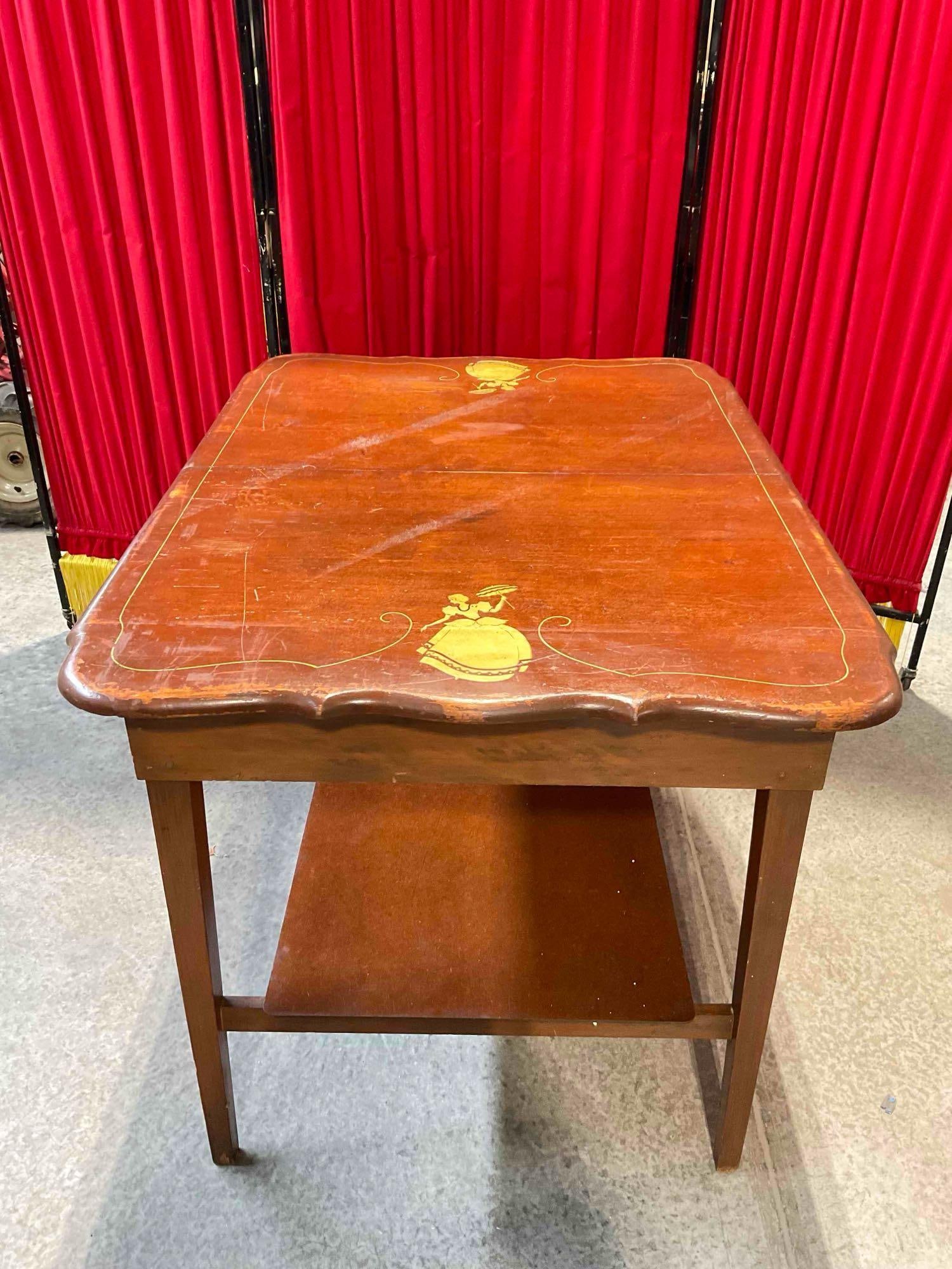 Vintage Charming Two-Tier Wooden Table w/ Painted Lady Design. Measures 42" x 32" x 31": Vintage Charming Two-Tier Wooden Table w/ Painted Lady Design. Measures 42" x 32" x 31" unsure of wood, could be maple? Piece has wear indicative of age and use, second tier looks to be of wood