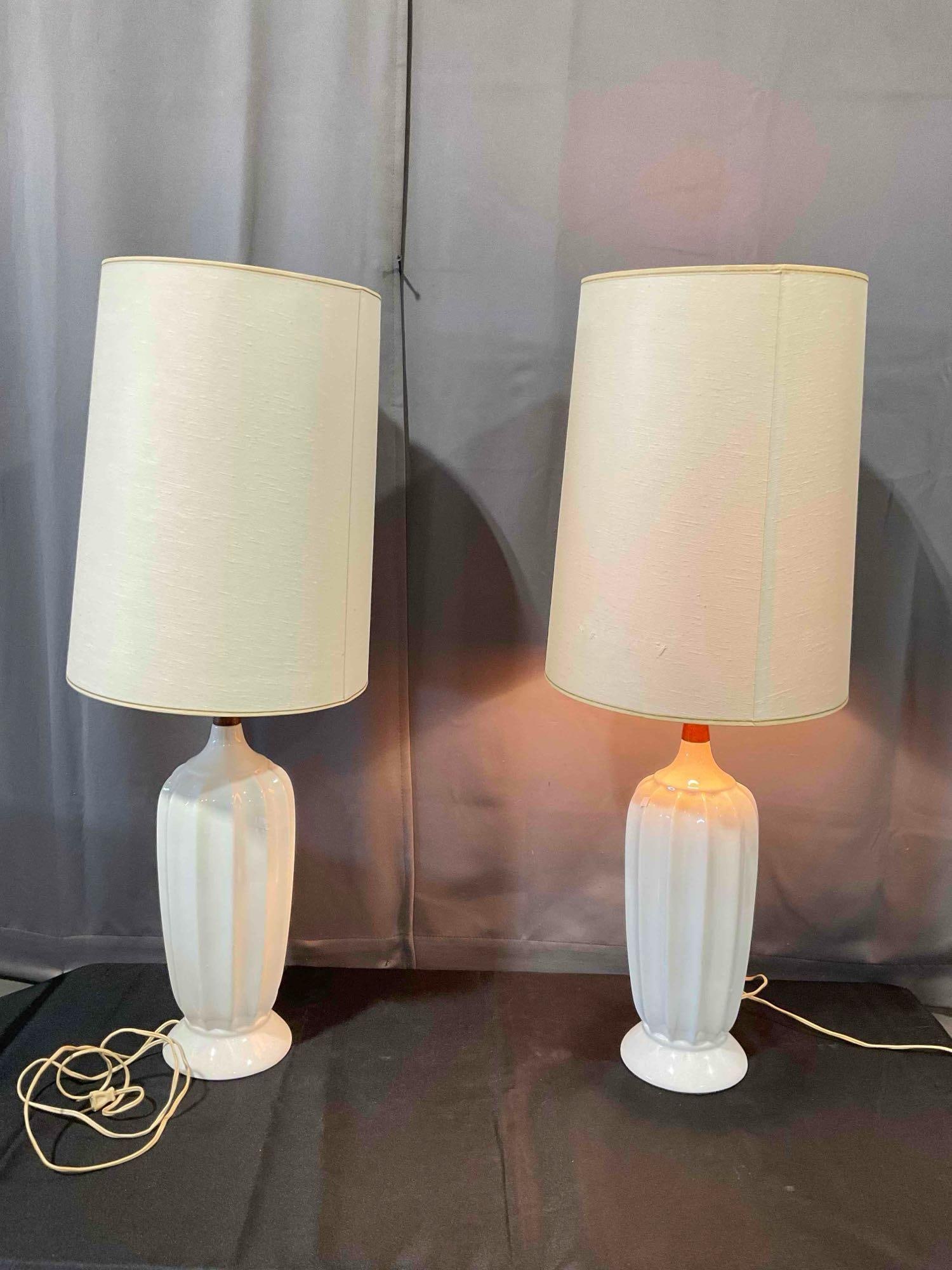 Pair of Vintage MCM White Ceramic & Walnut Wood Table Lamps w/ Cream Shades. Tested, Work.: Pair of Vintage MCM White Ceramic & Walnut Wood Table Lamps w/ Cream Shades. Tested, Work. Minor wear indicative of age and use, otherwise look to be in good condition. Measures 13" x 13" x 36" Dm