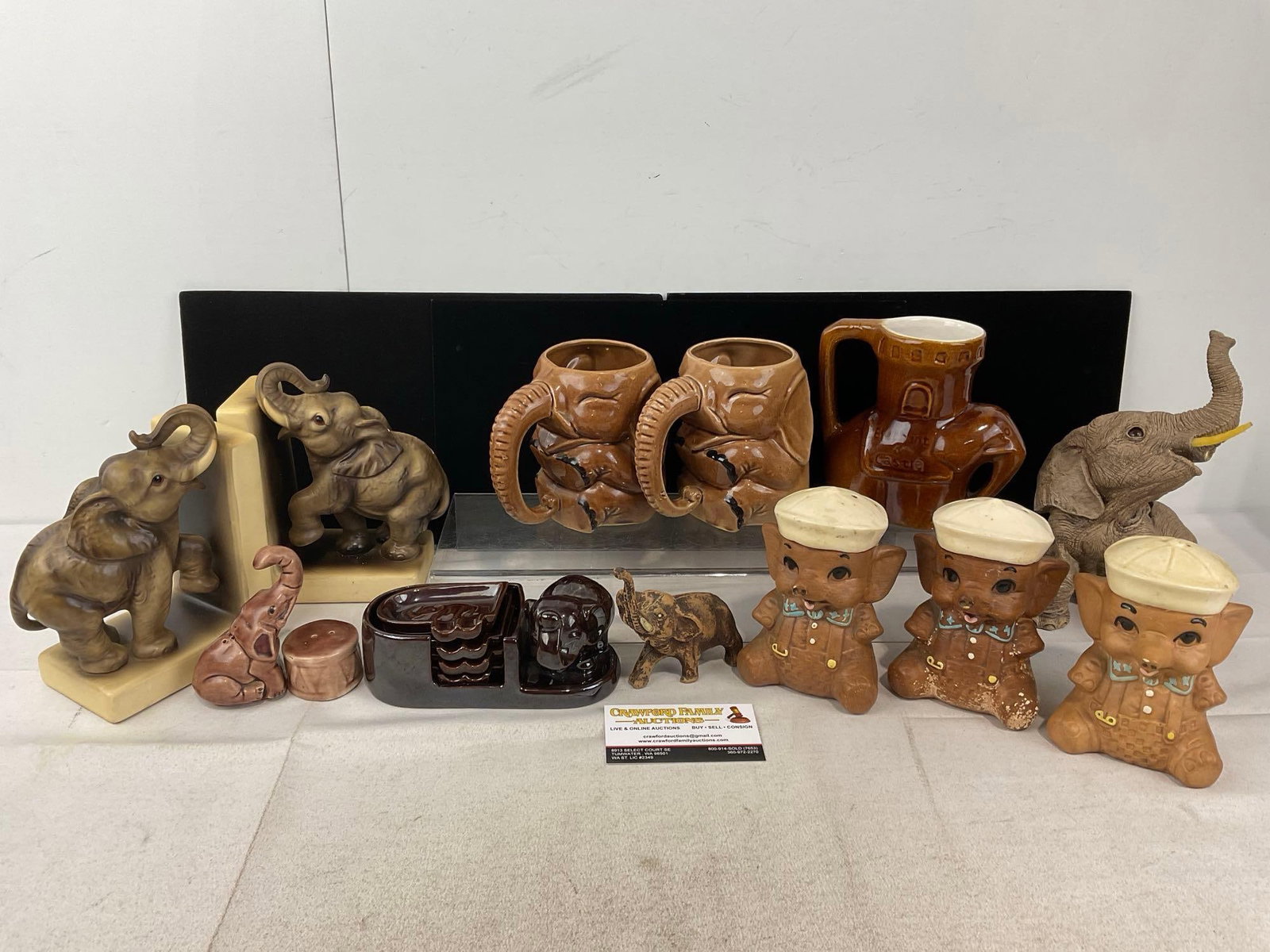 Elephant Shaped Glazed Ceramic Book Ends, Mugs, Salt & Pepper Shakers, Ashtrays, & more: Appears to be in good shape. The piece measures approx 14h x 12w x 15d inches. See pics. E-6230