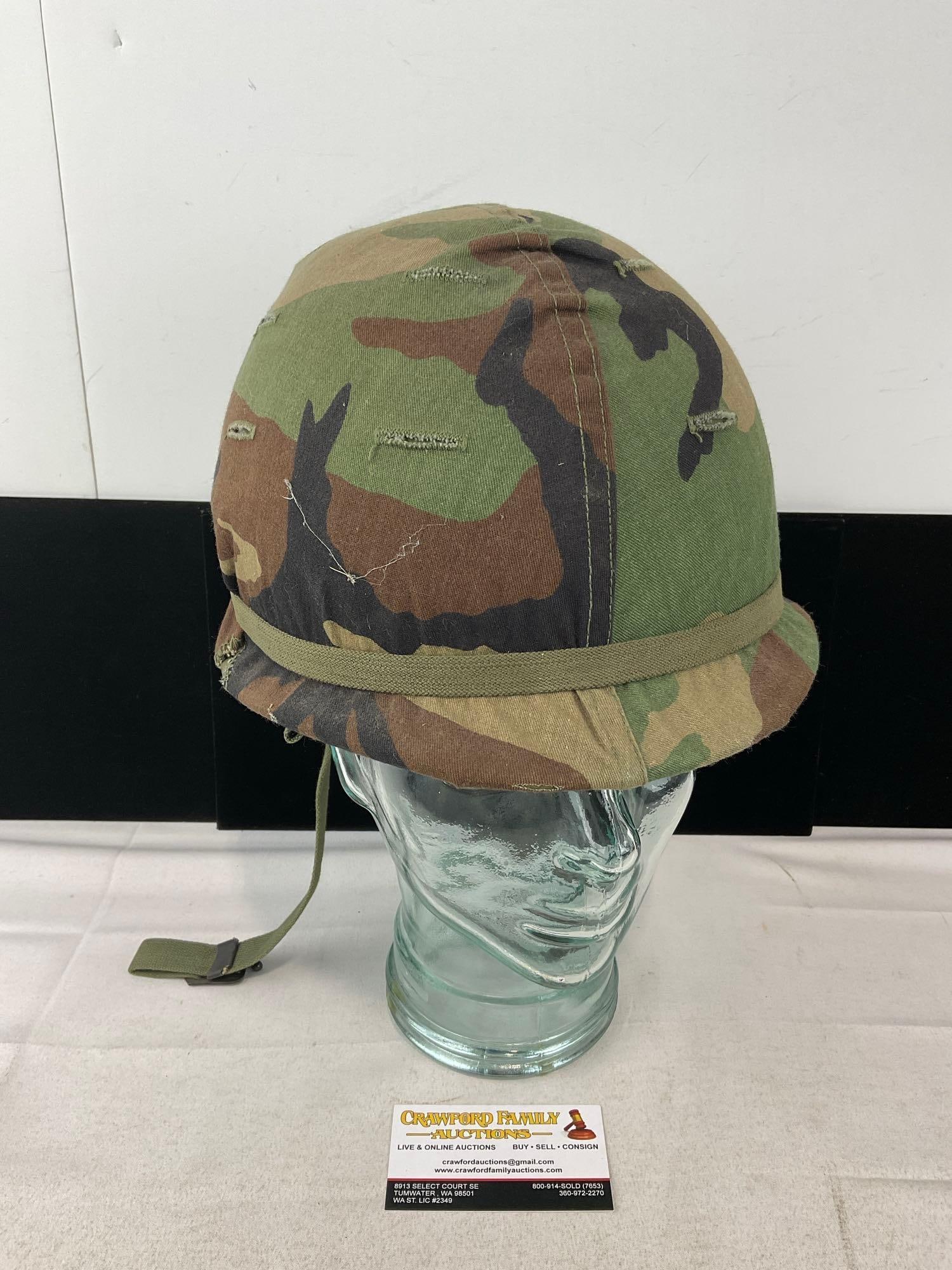 Vintage US Military M-1 Combat Helmet w/Woodland Camo cover, Vietnam Era: Appears to be in good shape. The piece measures approx 9h x 11w x 10d inches. See pics. E-6400