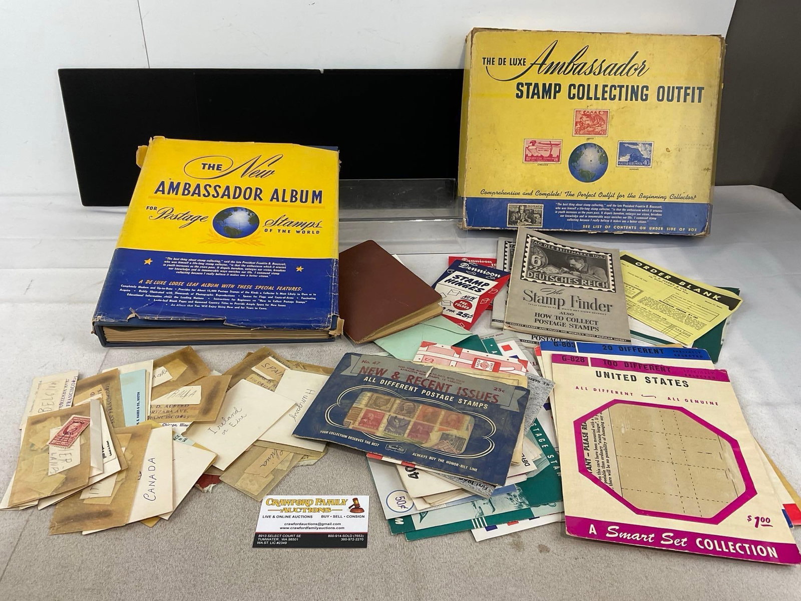 The De Luxe Ambassador Stamp Collecting Outfit, & Album, including stamps: Pictures of the inside of the album are just a sample, decent variety, few stamps on each page. Appears to be in good shape. The piece measures approx 4h x 14w x 11d inches. See pics. E-6230