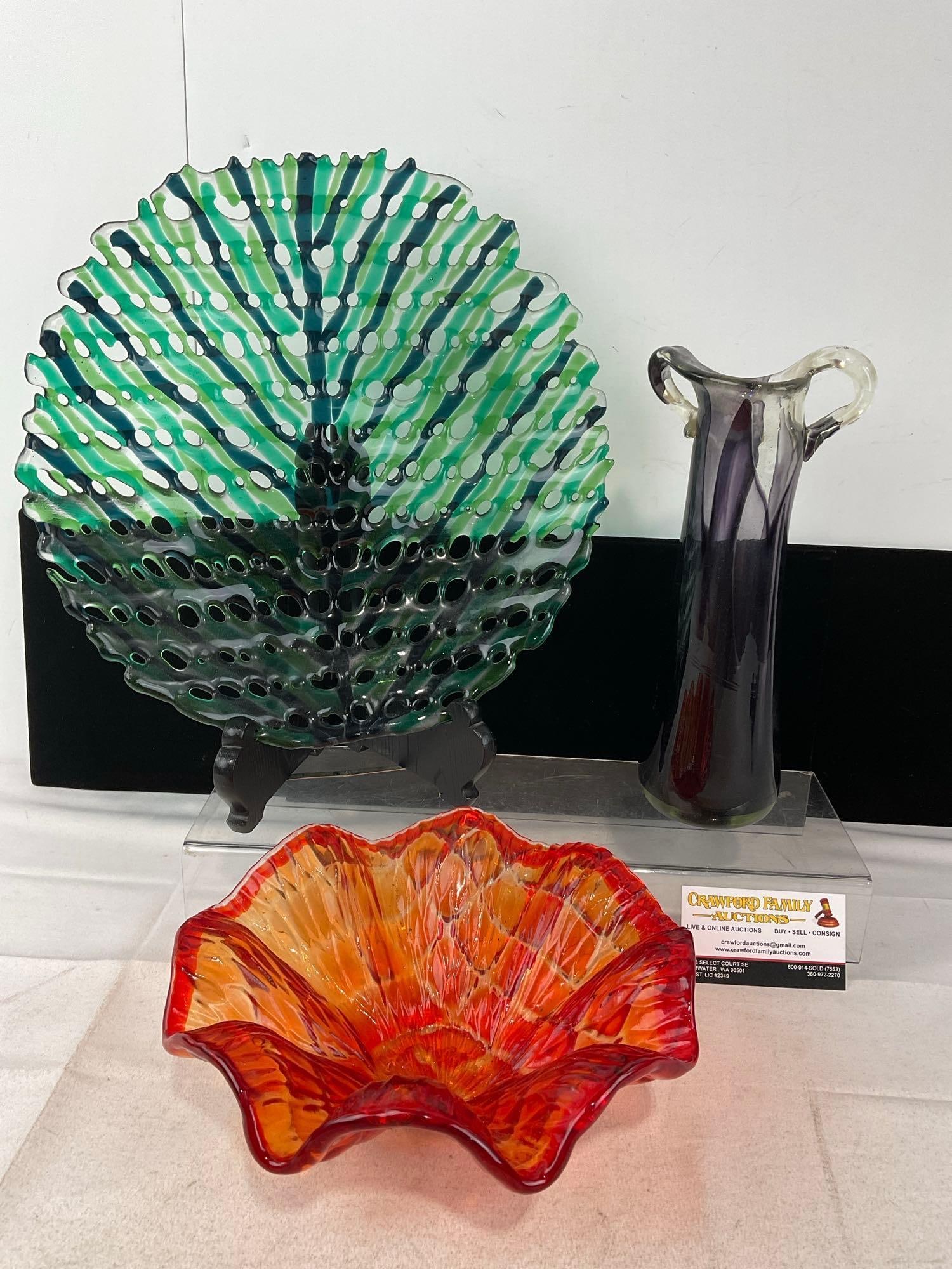 Green/Blue Fused Glass Decorative Plate, Firey Colored Frilled Dish, & Purple/Clear Bud Vase: The larger piece looks to be signed, seen on the back. Appears to be in good shape. The piece measures approx 6h x 14w x 14d inches. See pics. E-6230