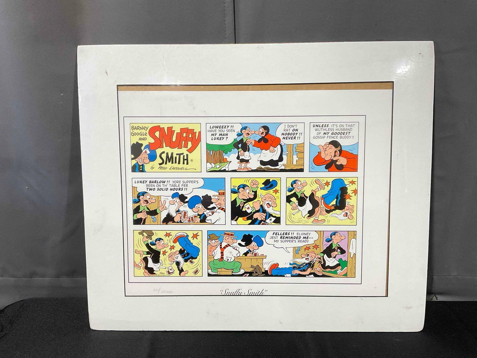 Vintage Unframed Comic Strip Print "Snuffy Smith" by Fred Lasswell Ltd. Ed. 60/2500, w/ COA.: Vintage Unframed Comic Strip Print "Snuffy Smith" by Fred Lasswell Ltd. Ed. 60/2500, w/ COA. Has wear to plastic wrapping, improperly centered, otherwise in fair condition. Pair to lot #70. Measures