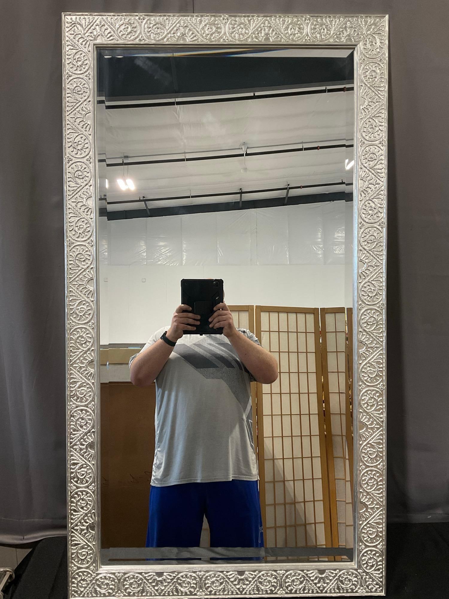 Tall Rectangular Mirror, Embossed Silver Painted Frame, 55x30 inches: *No in-house shipping due to size* Appears to be in good shape. The piece measures approx 55h x 30w x 3d inches. See pics. E-6290 *Freight Required if shipped, Buyer Arranged/Responsibility*