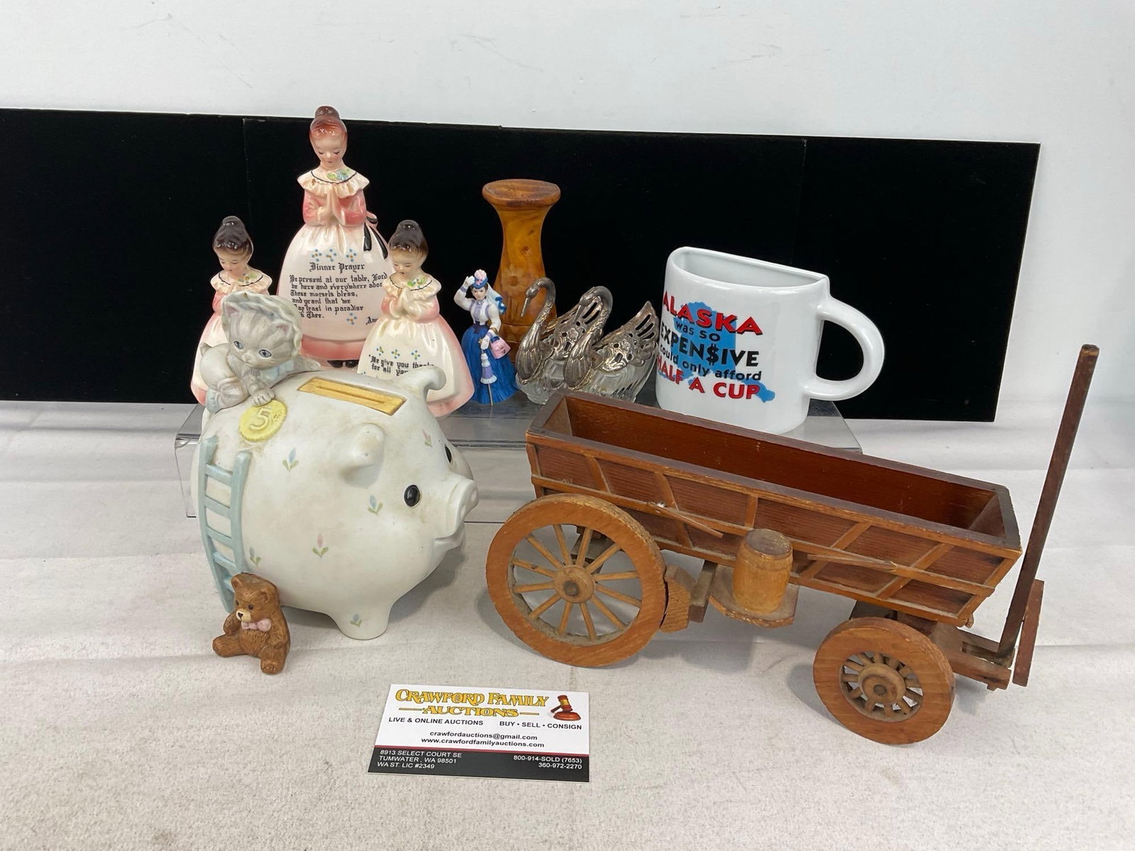 Piggy Bank, Wooden Cart Figure, Vintage Praying Woman Figures & Napkin Holder, Wooden Vase & more: Alaska Novelty half coffee cup, 2x Glass Geese w/ silver plate? heads & wings. Appears to be in good shape. The pieces fit in a box that measures approx 9h x 13w x 13d inches. See pics. E-6240