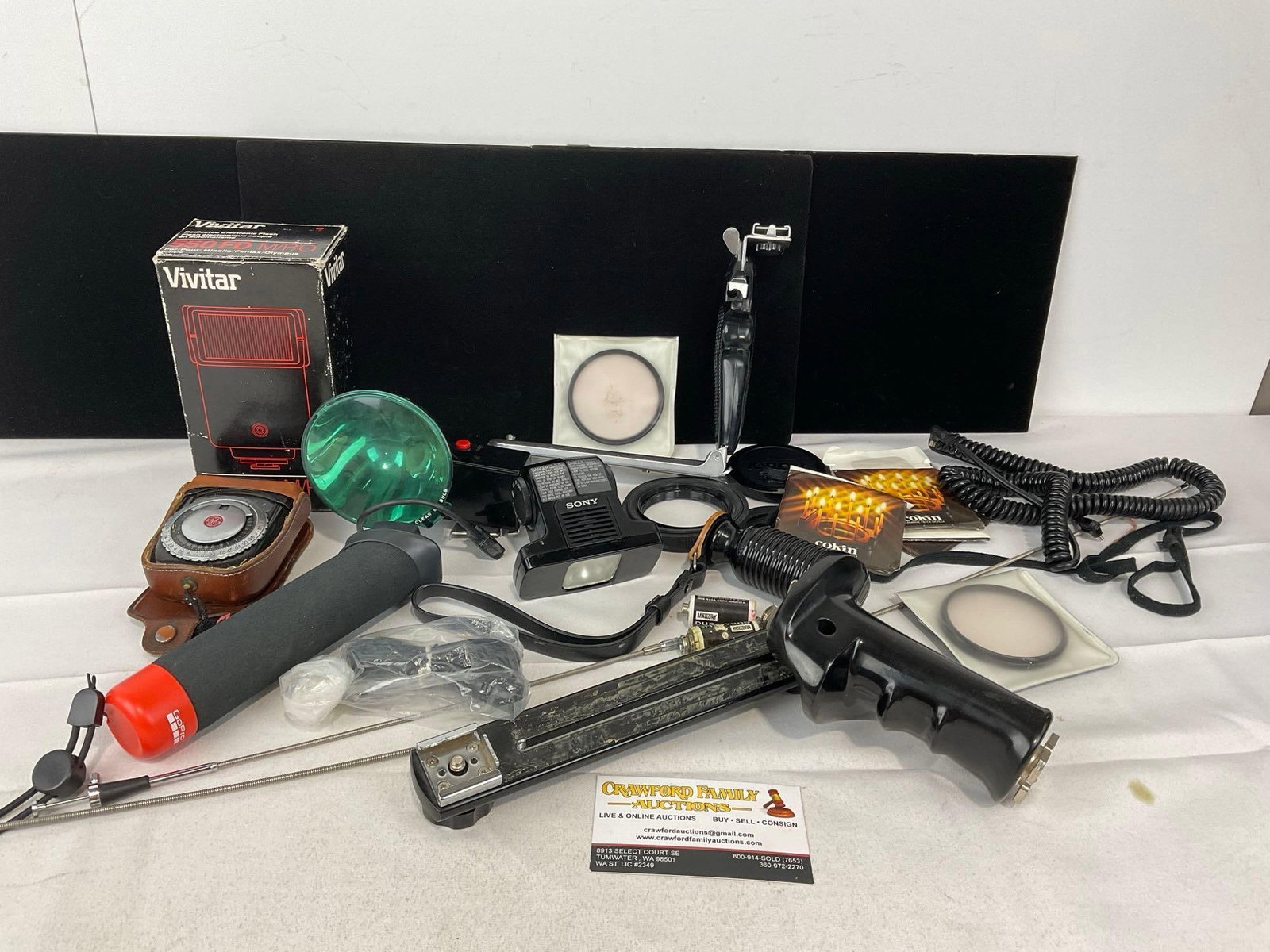 Asst Camera Accessories, Vivitar Flash Module & more, couple Grips, Filters: Appears to be in good shape. The piece measures approx 9h x 10w x 7d inches. See pics. E-414