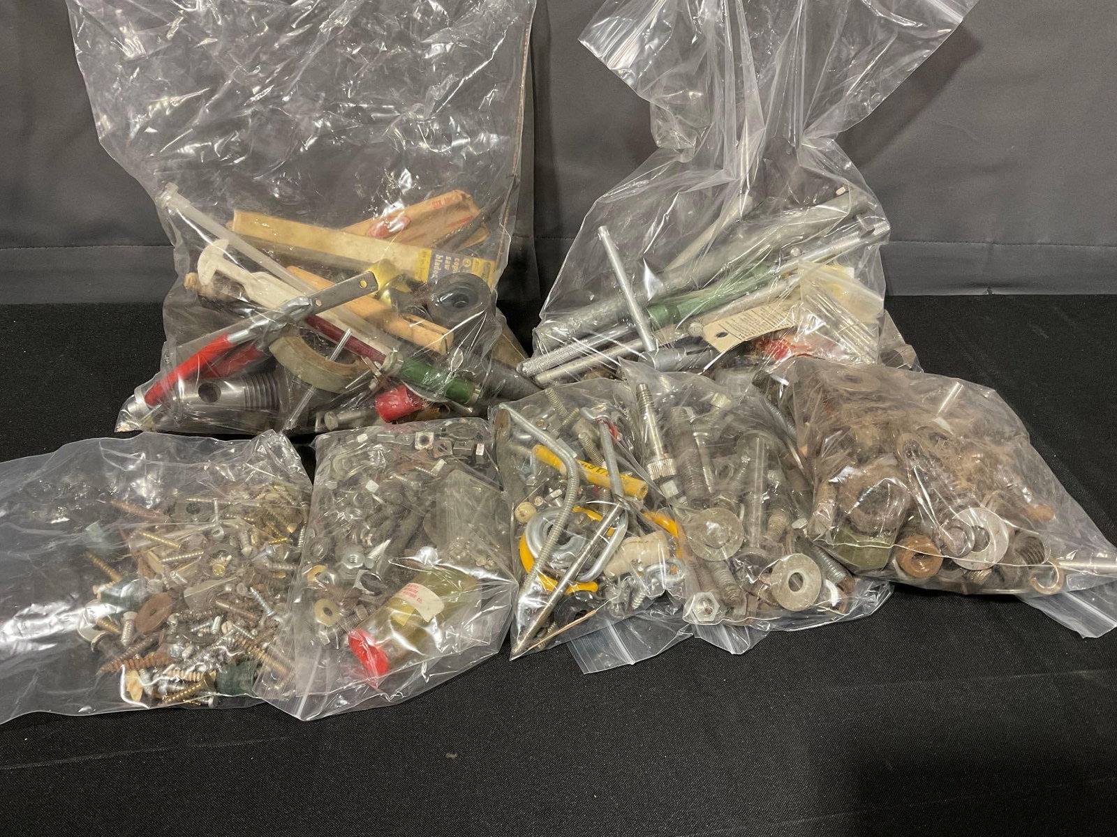assorted nuts, bolts, and other fasteners, in bags, uncounted: Appears to be a mixed variety, some are screws, bolts, nuts, tools & more. All together fits in a box that measures approx 10 x 13 x 13 inches. See pics. E-414